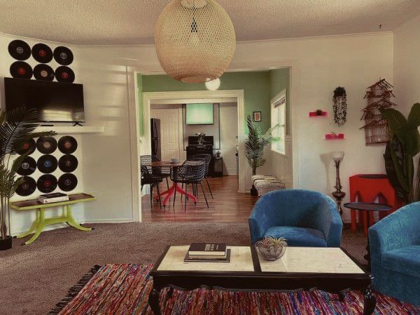 A living room with two blue chairs and a coffee table