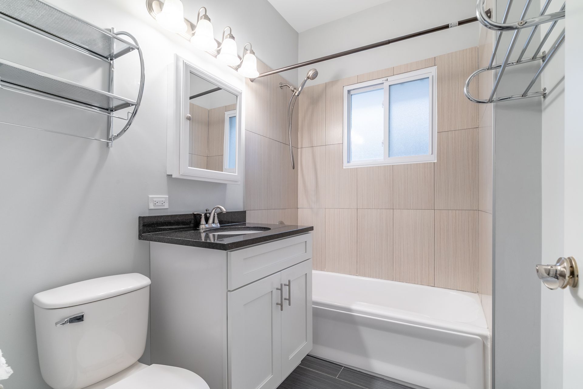 A bathroom with a toilet , sink , and bathtub.