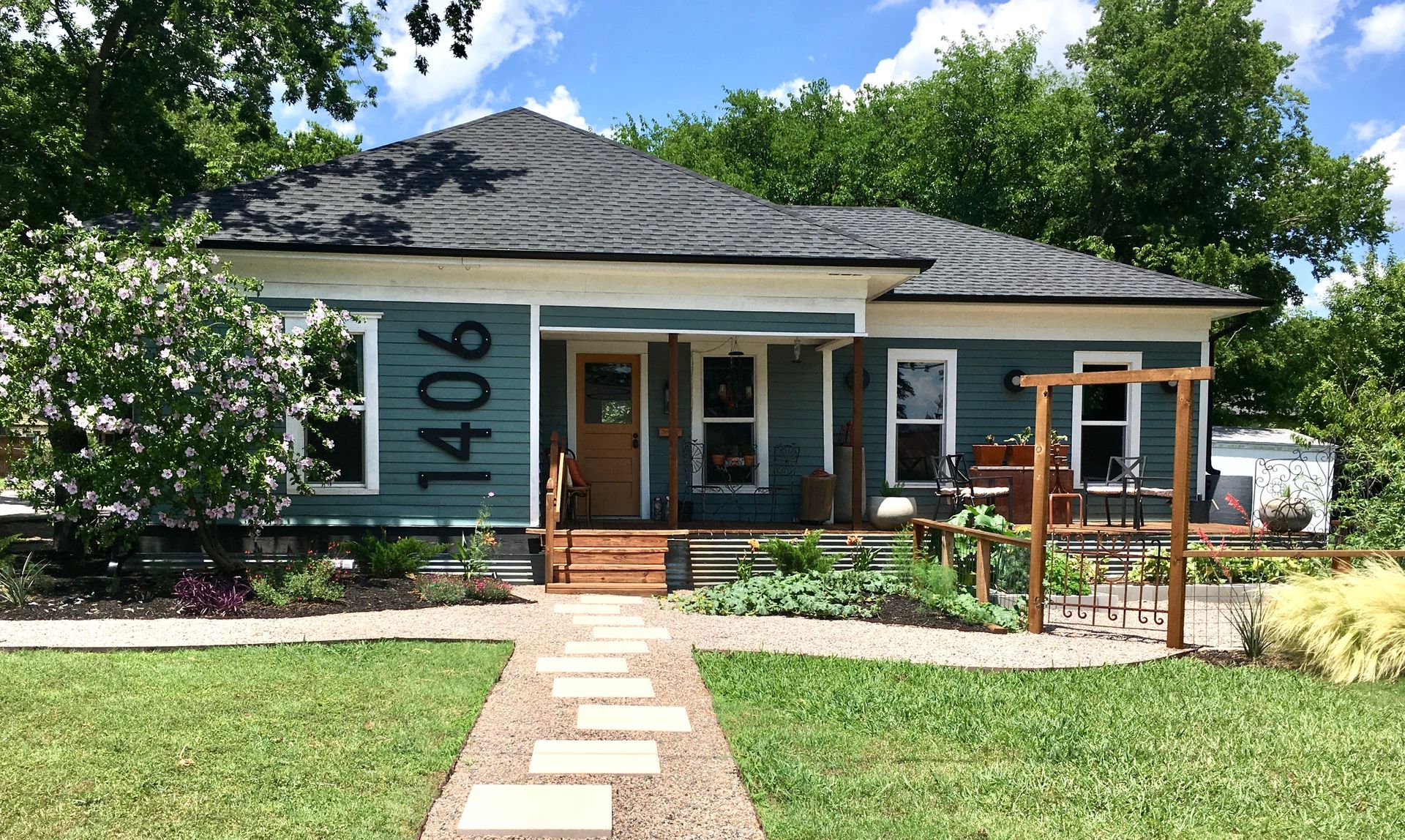 A blue house with the number 1406 painted on the front of it.
