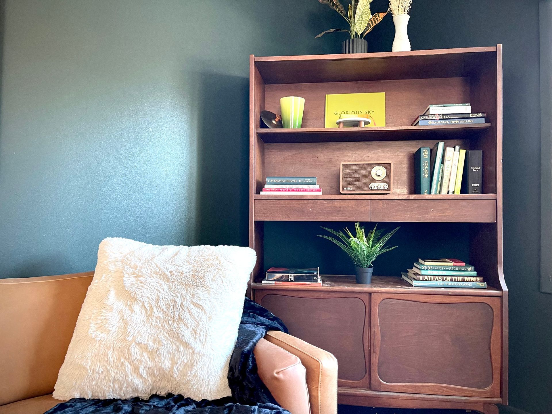 A living room with a bookshelf and a couch