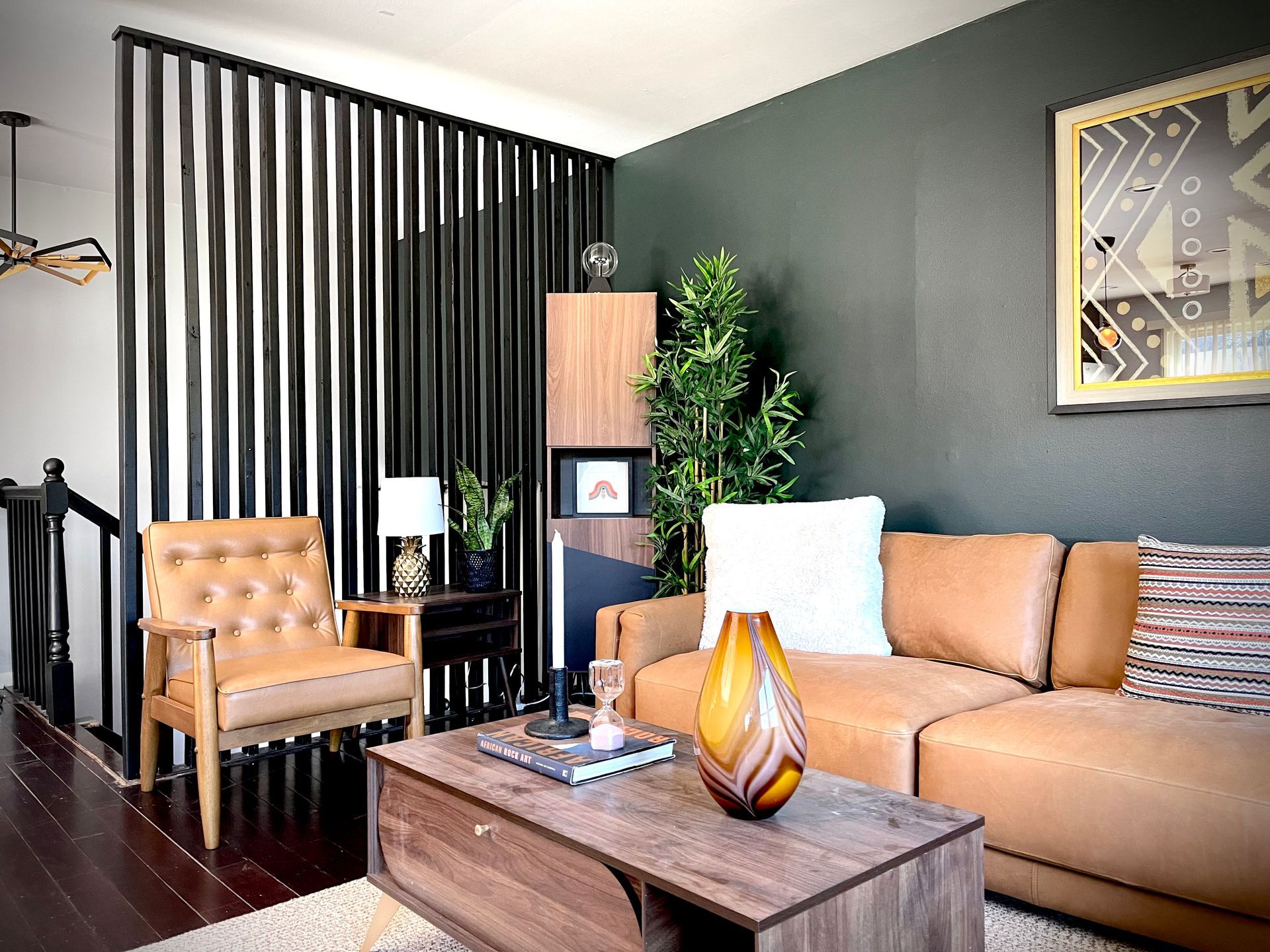 A living room with a couch , chair and coffee table.
