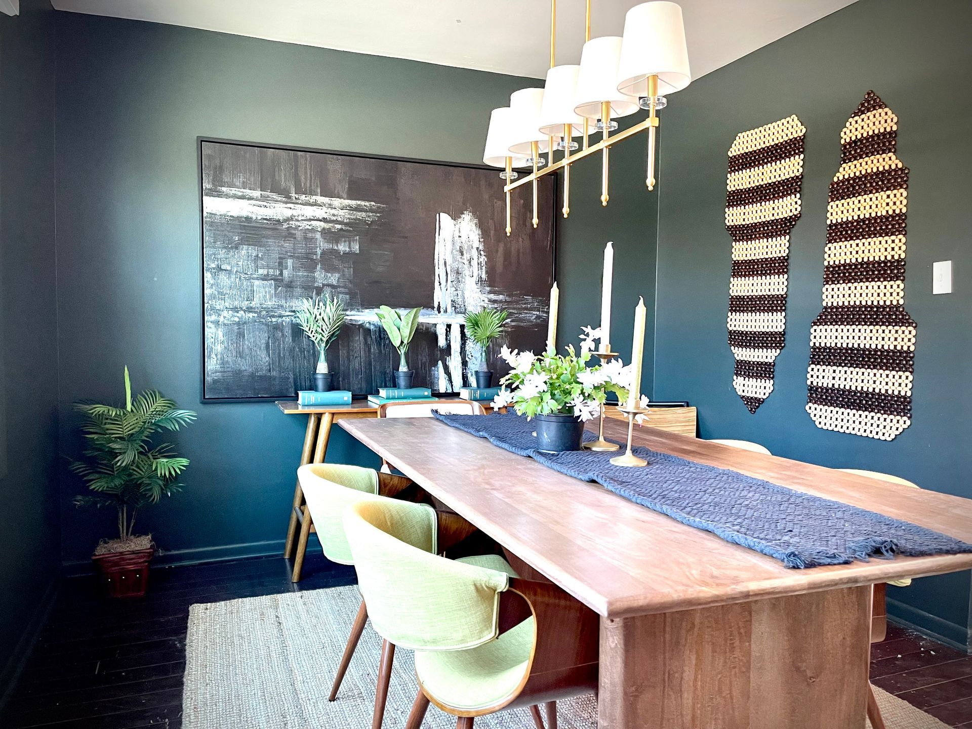 A dining room with a long wooden table and chairs.
