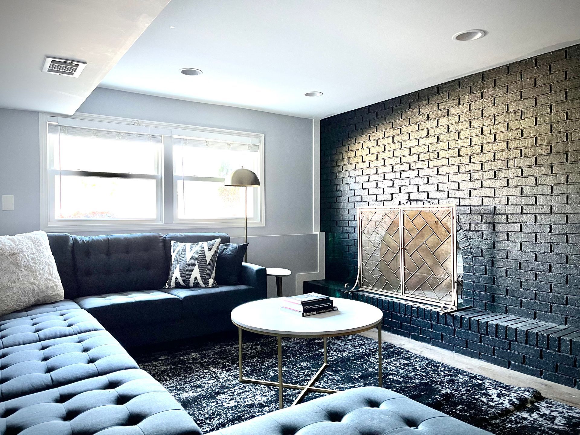 A living room with a couch , coffee table , and fireplace.