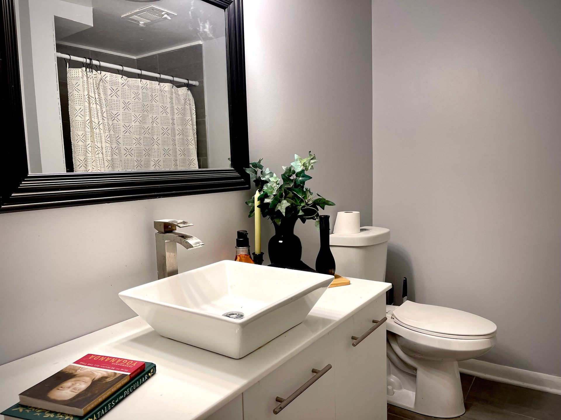 A bathroom with a sink , toilet and mirror