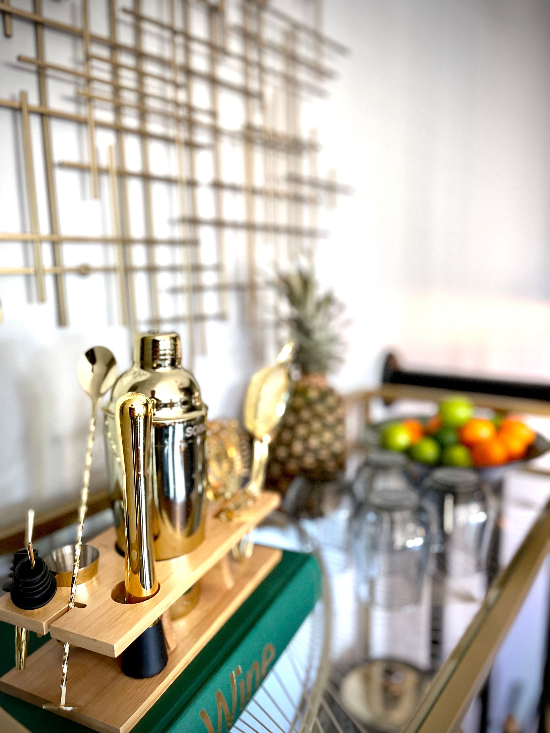 A shaker is sitting on top of a wooden tray on a table.