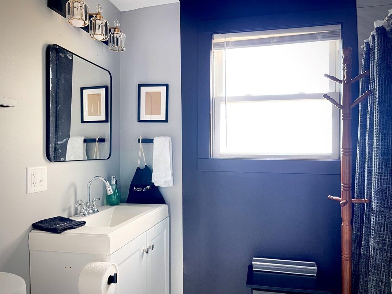 A bathroom with a sink a mirror and a window
