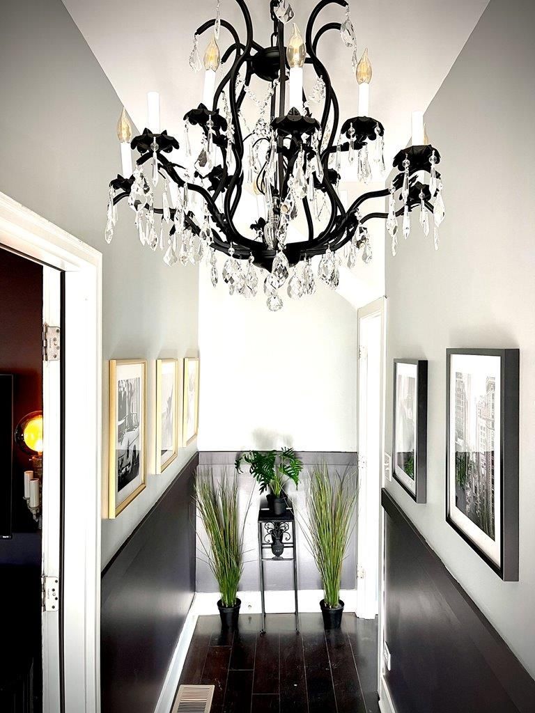 A hallway with a chandelier hanging from the ceiling