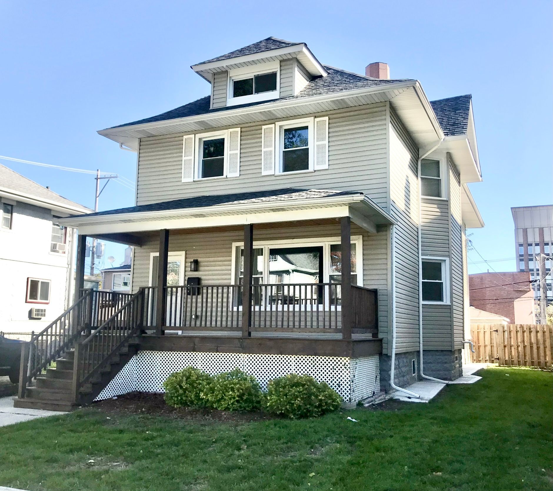 A large house with a large porch and stairs