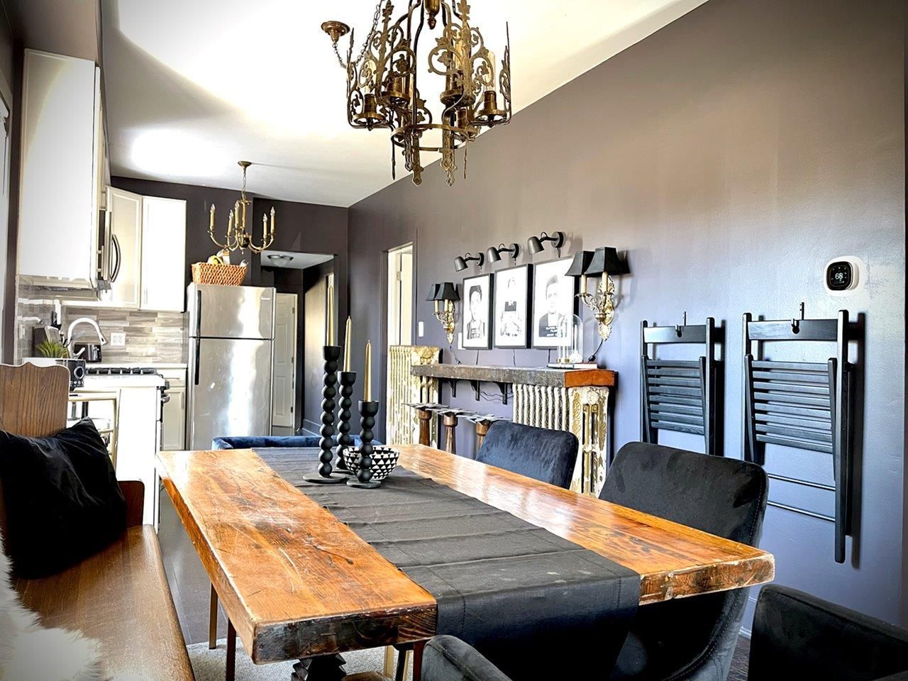 A dining room with a long wooden table and chairs