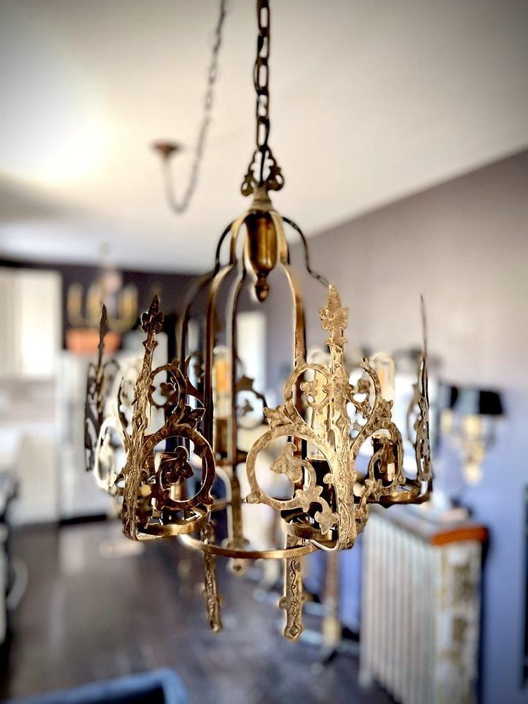 A brass chandelier is hanging from the ceiling in a living room.