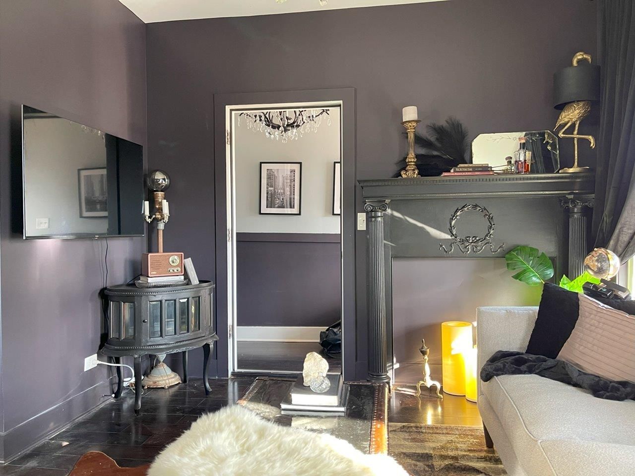 A living room with a couch , table , and mirror.