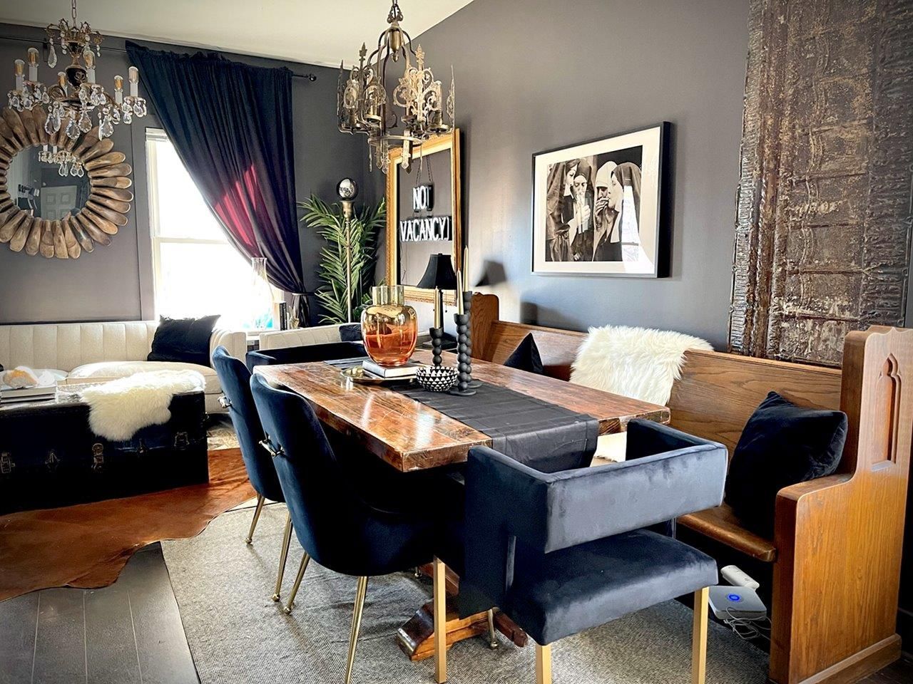A dining room with a table and chairs and a bench.