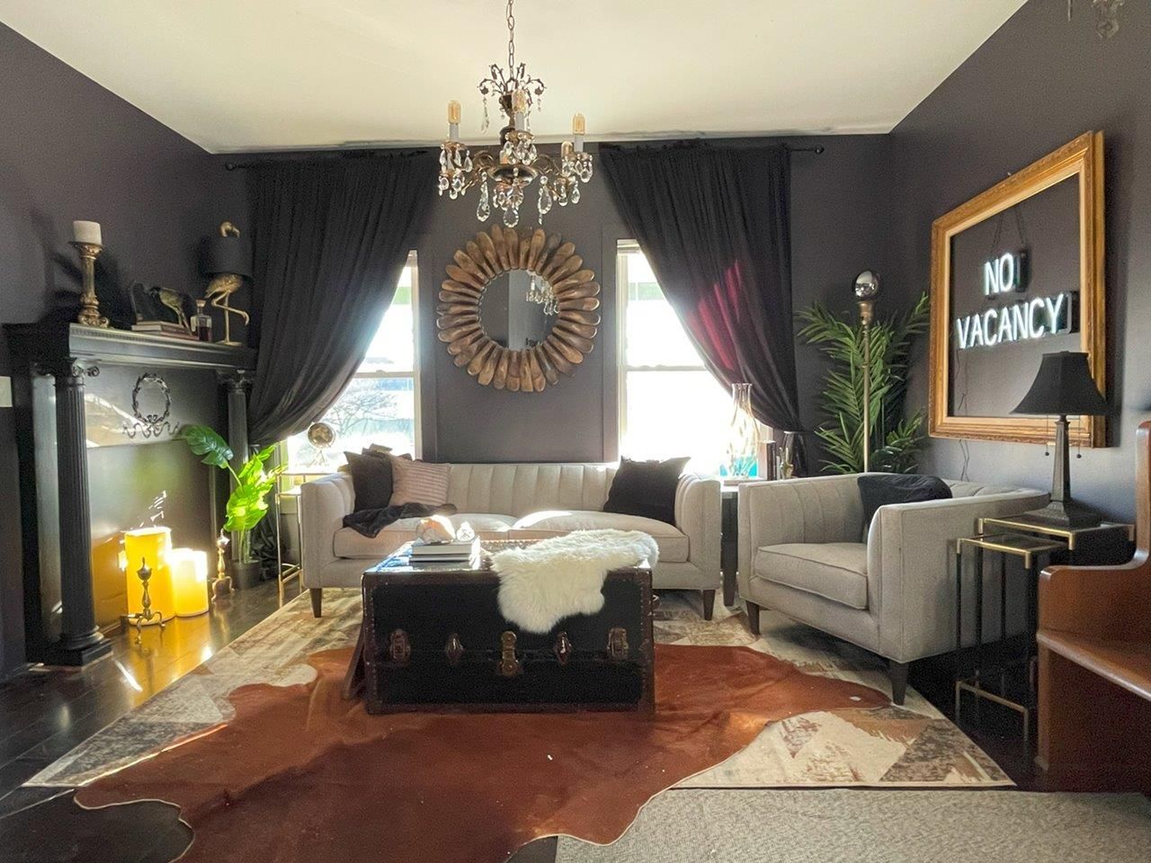 A living room with a couch and chairs and a sign that says no vacancy