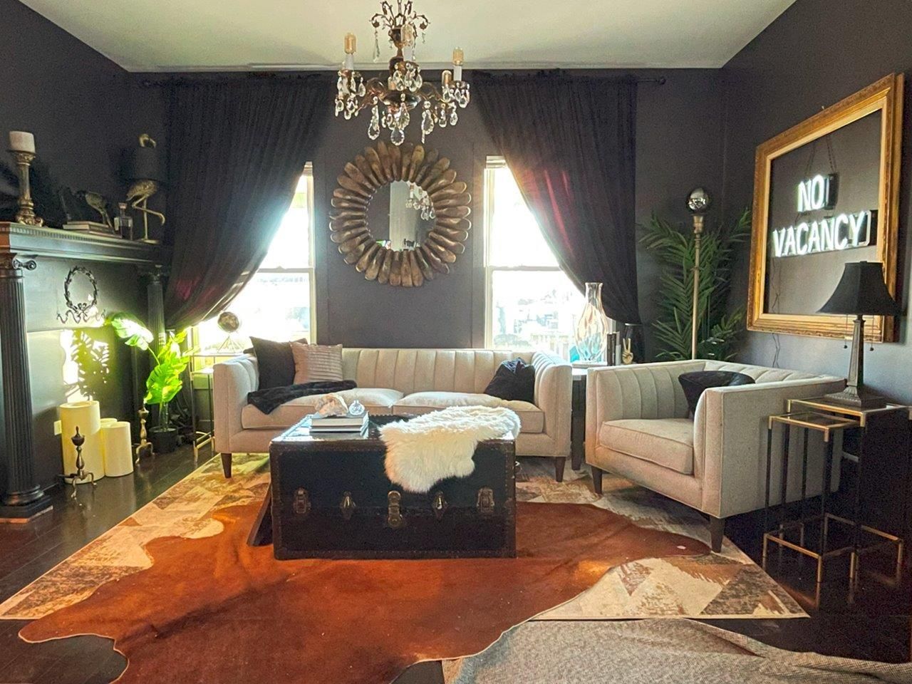 A living room with a couch and chairs and a sign that says no vacancy
