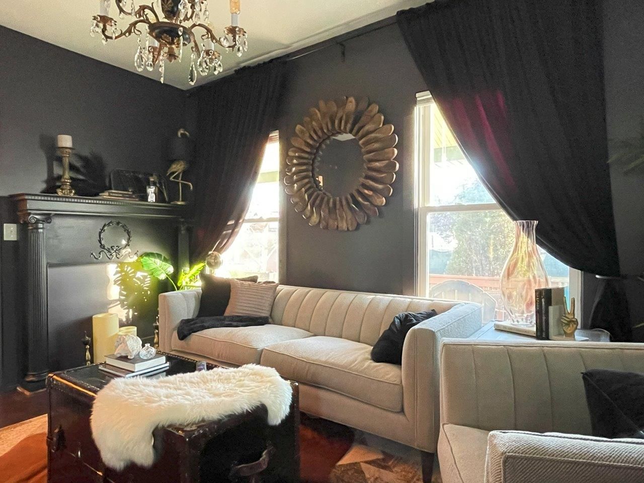 A living room with a couch , chairs , coffee table and fireplace.
