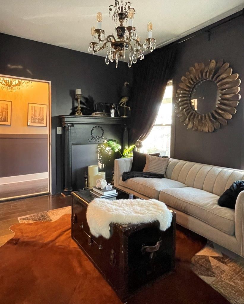 A living room with a couch a coffee table and a mirror