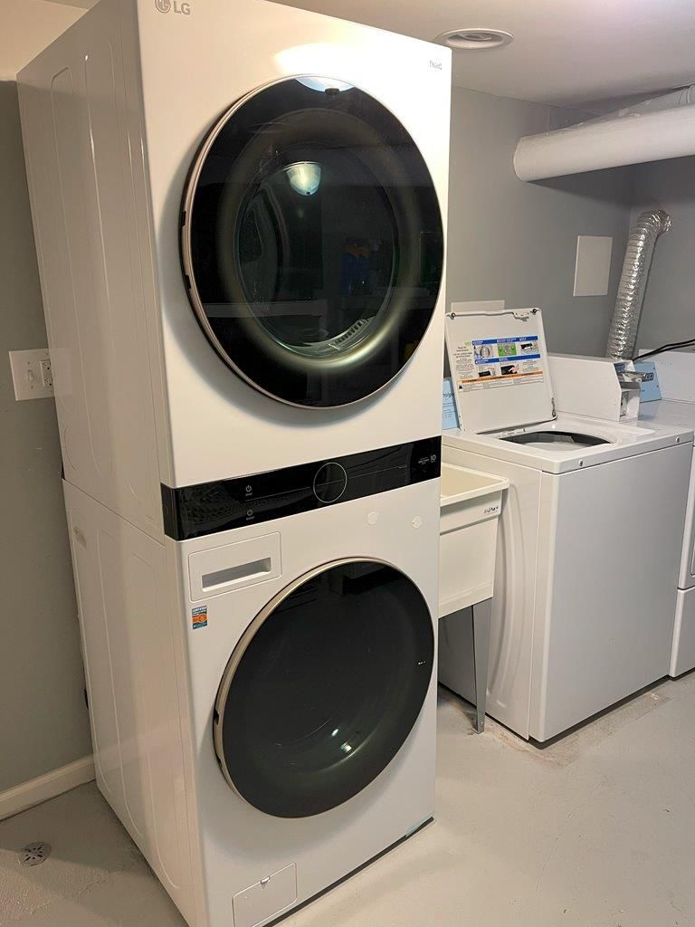 A washer and dryer are stacked on top of each other in a laundry room.