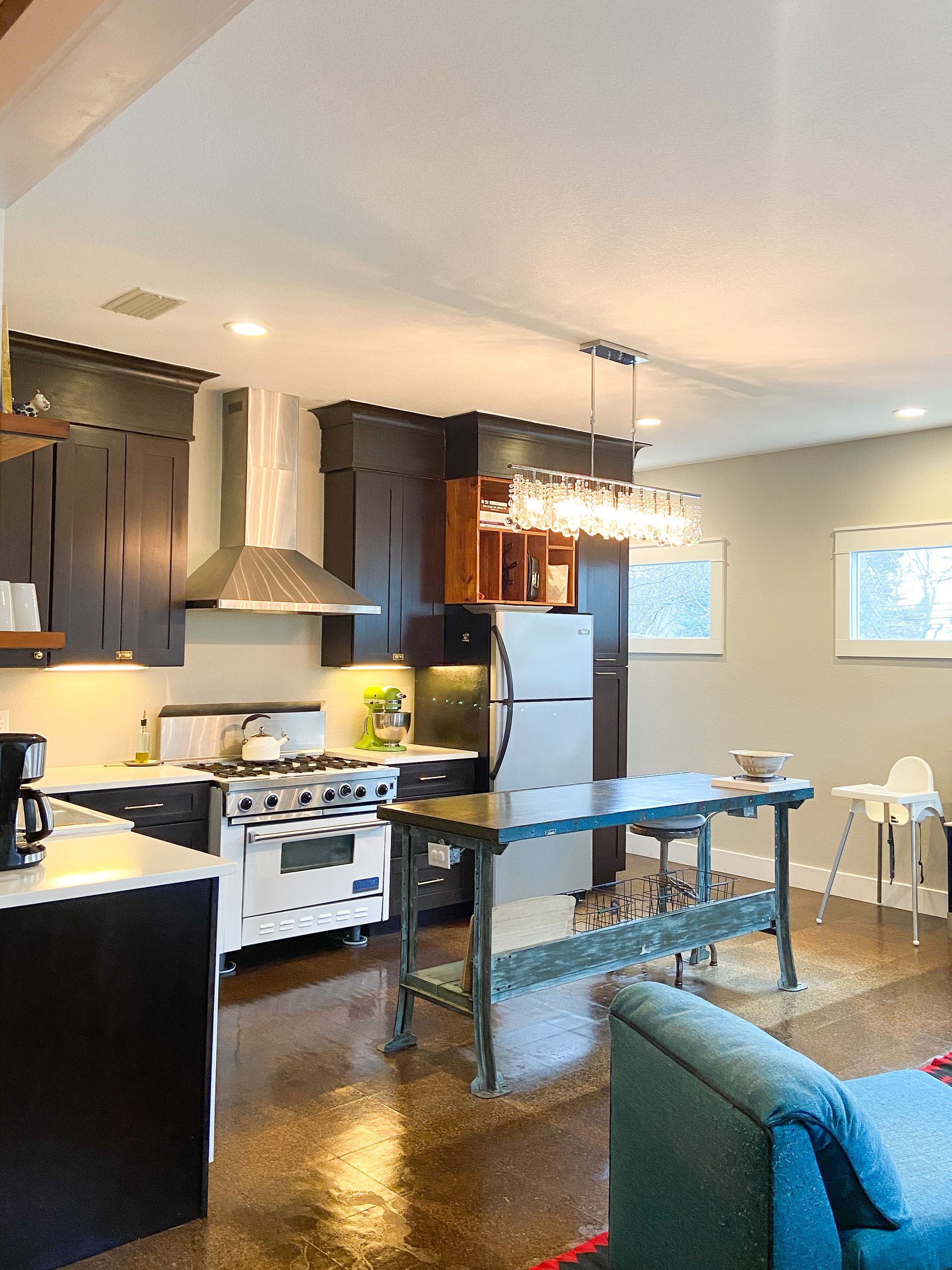 A kitchen with a stove a refrigerator and a table
