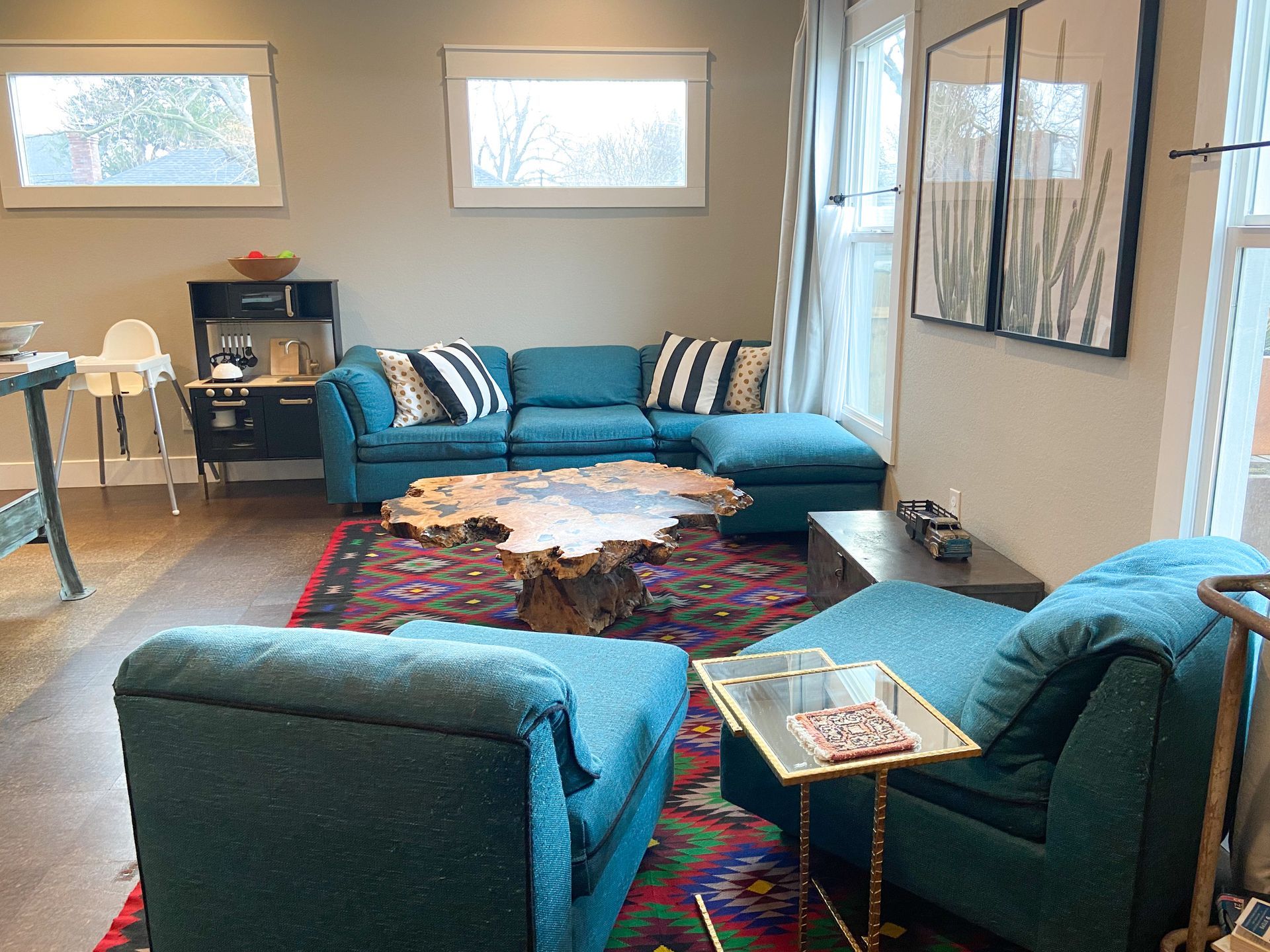 A living room with blue furniture and a wooden coffee table.
