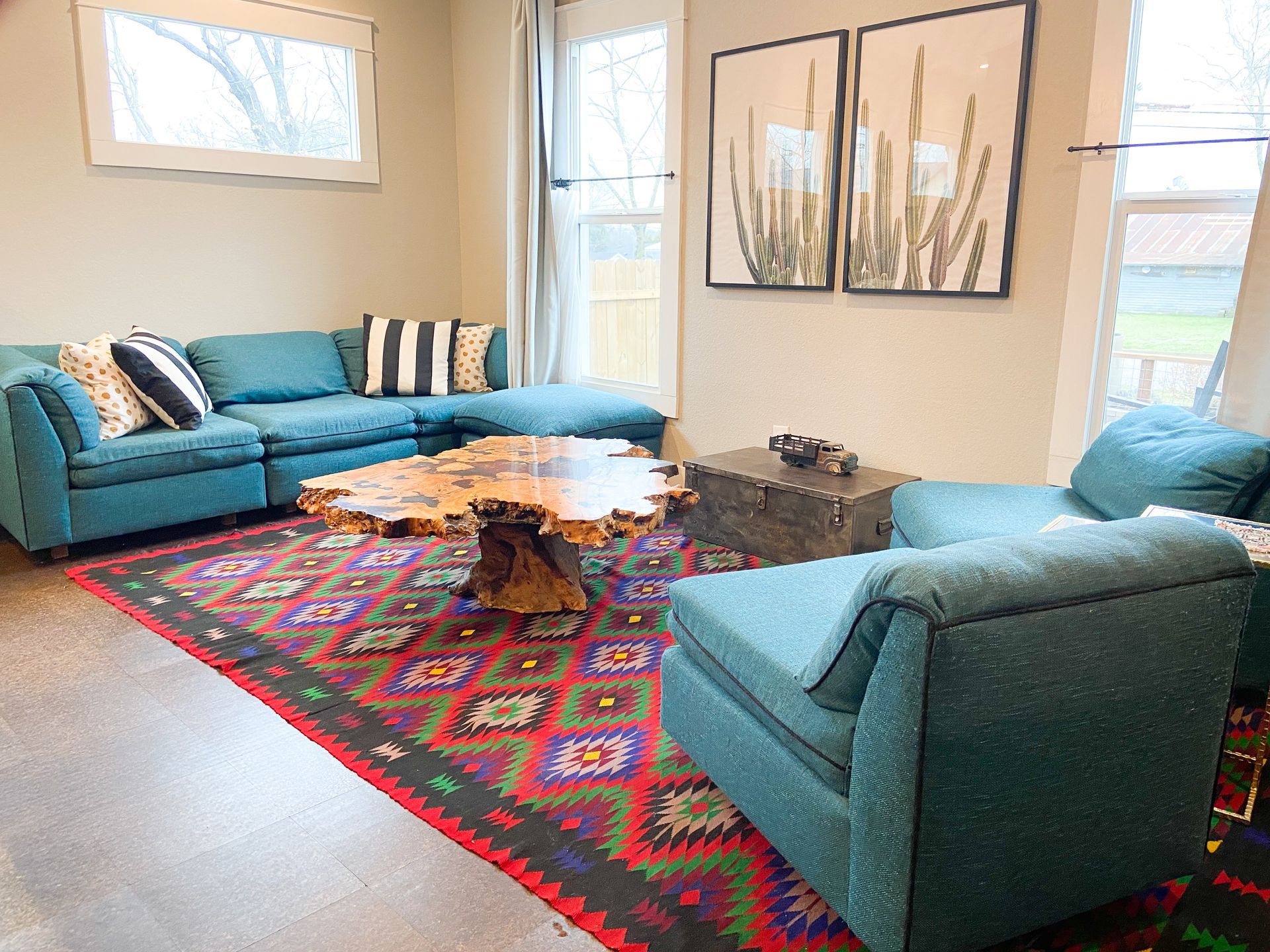 A living room filled with furniture and a rug.