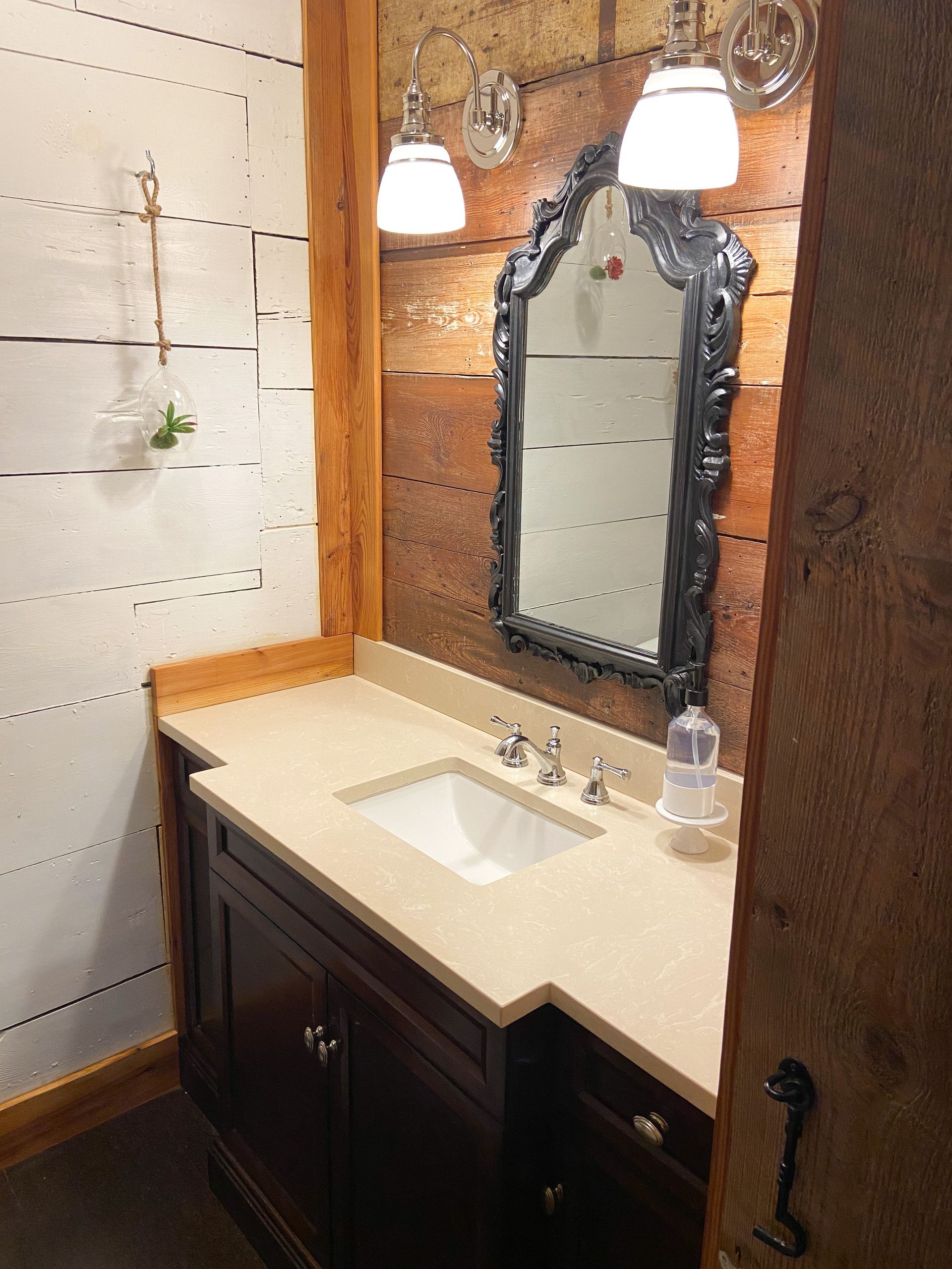 A bathroom with a sink and a mirror on the wall.
