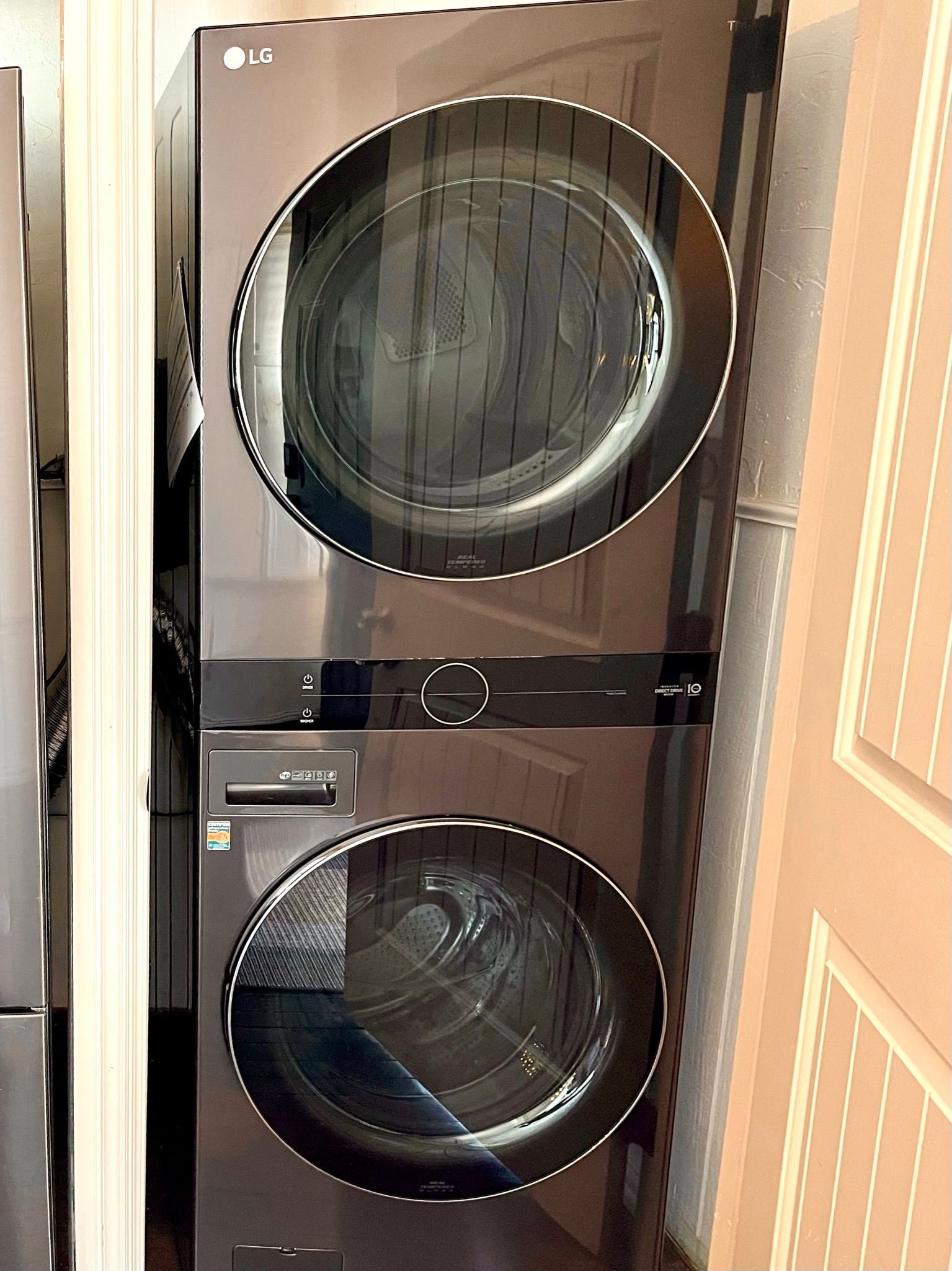 An lg washer and dryer are stacked on top of each other.