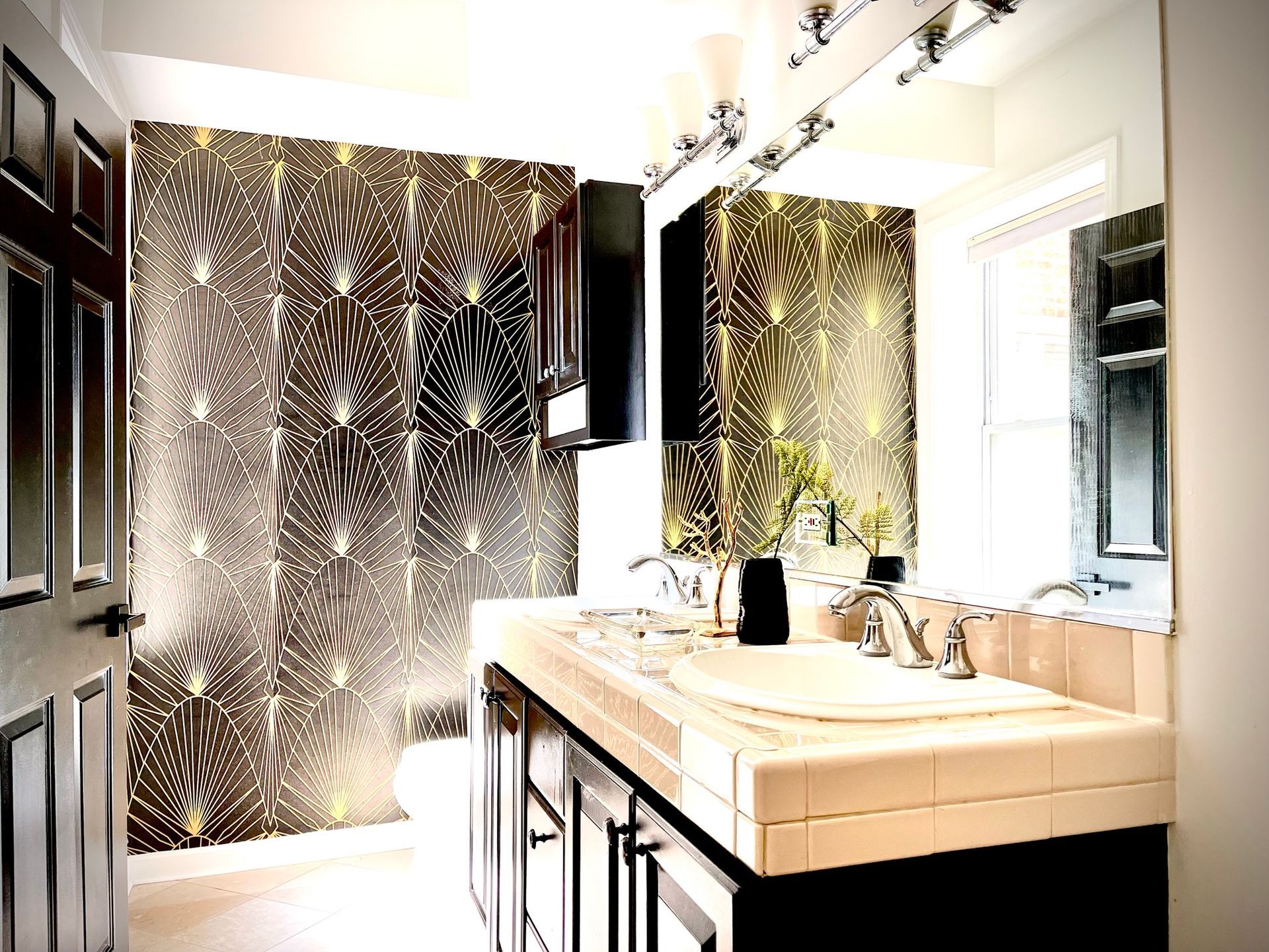 A bathroom with a sink and a large mirror
