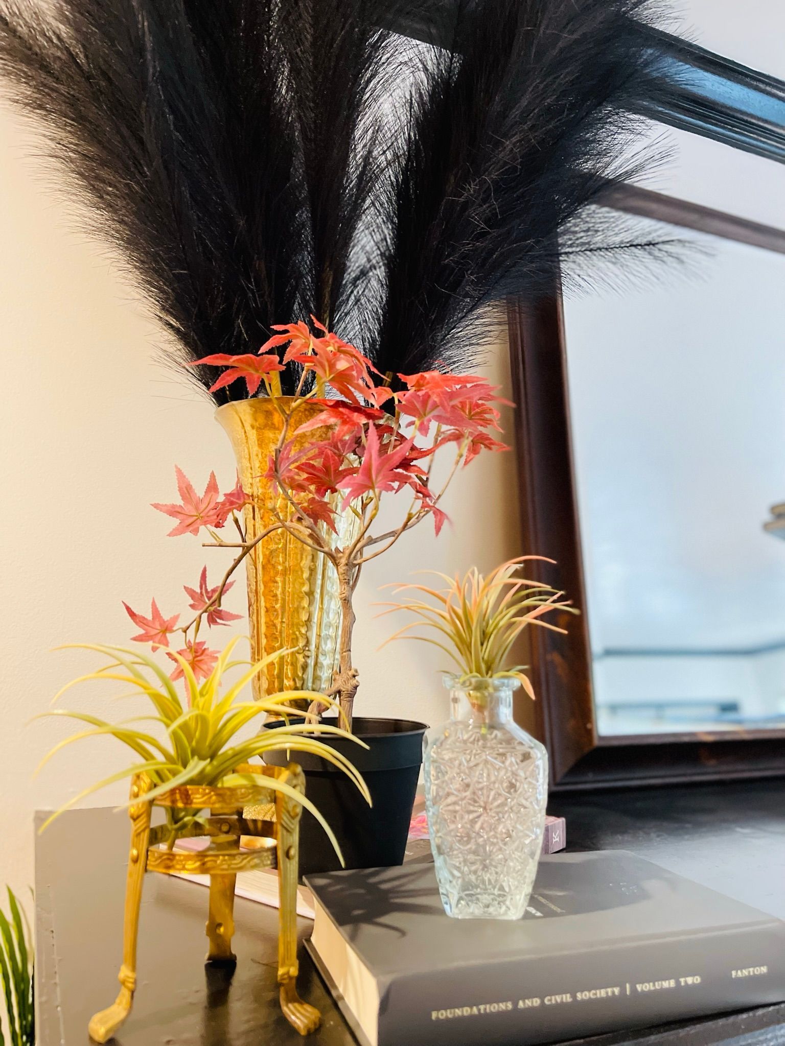 A vase filled with flowers is sitting on a table next to a book.
