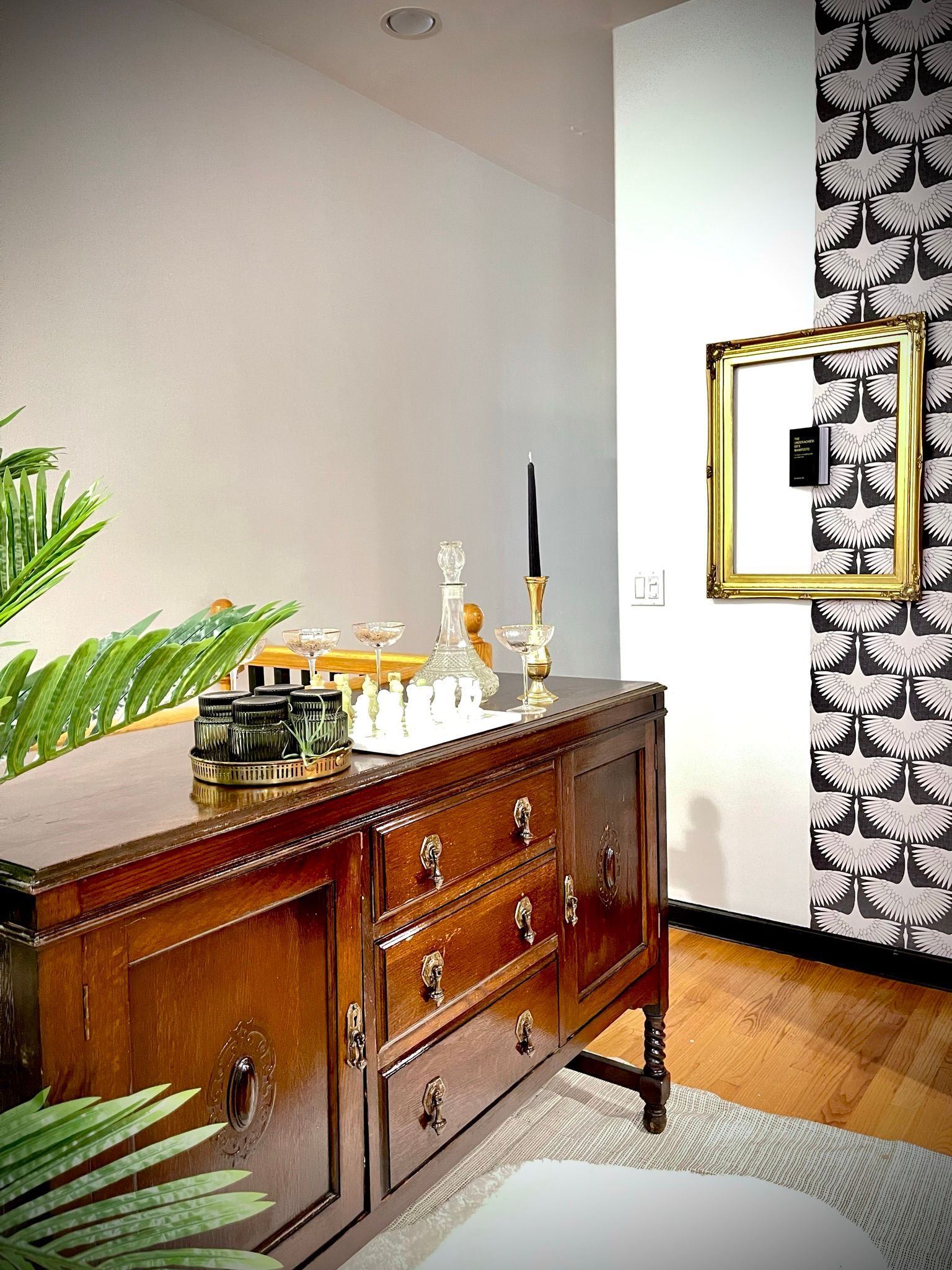 A room with a dresser and a picture frame on the wall