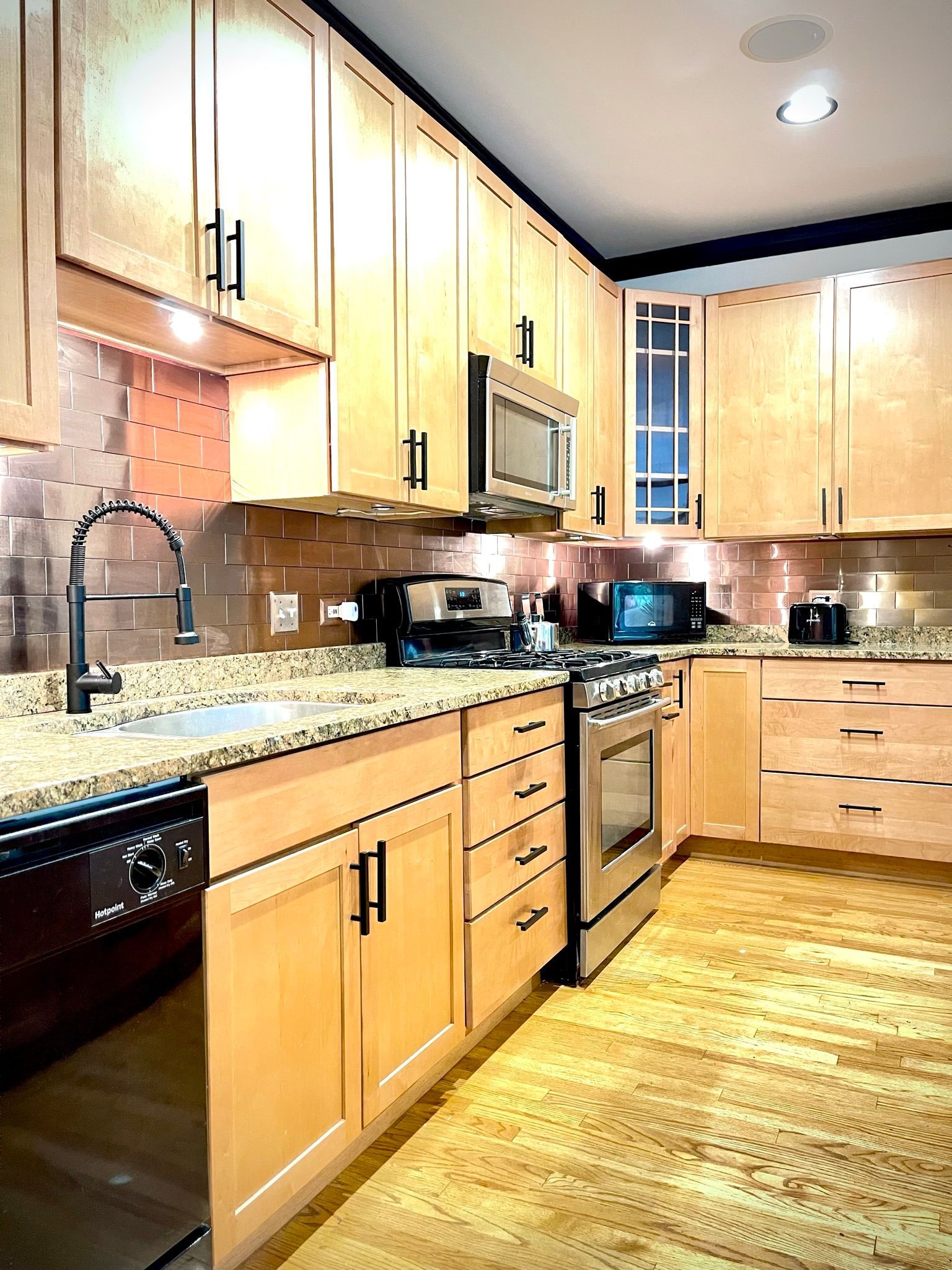 A kitchen with wooden cabinets and stainless steel appliances