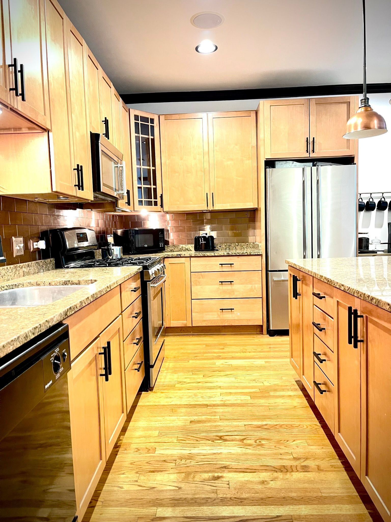 A kitchen with wooden cabinets and granite counter tops