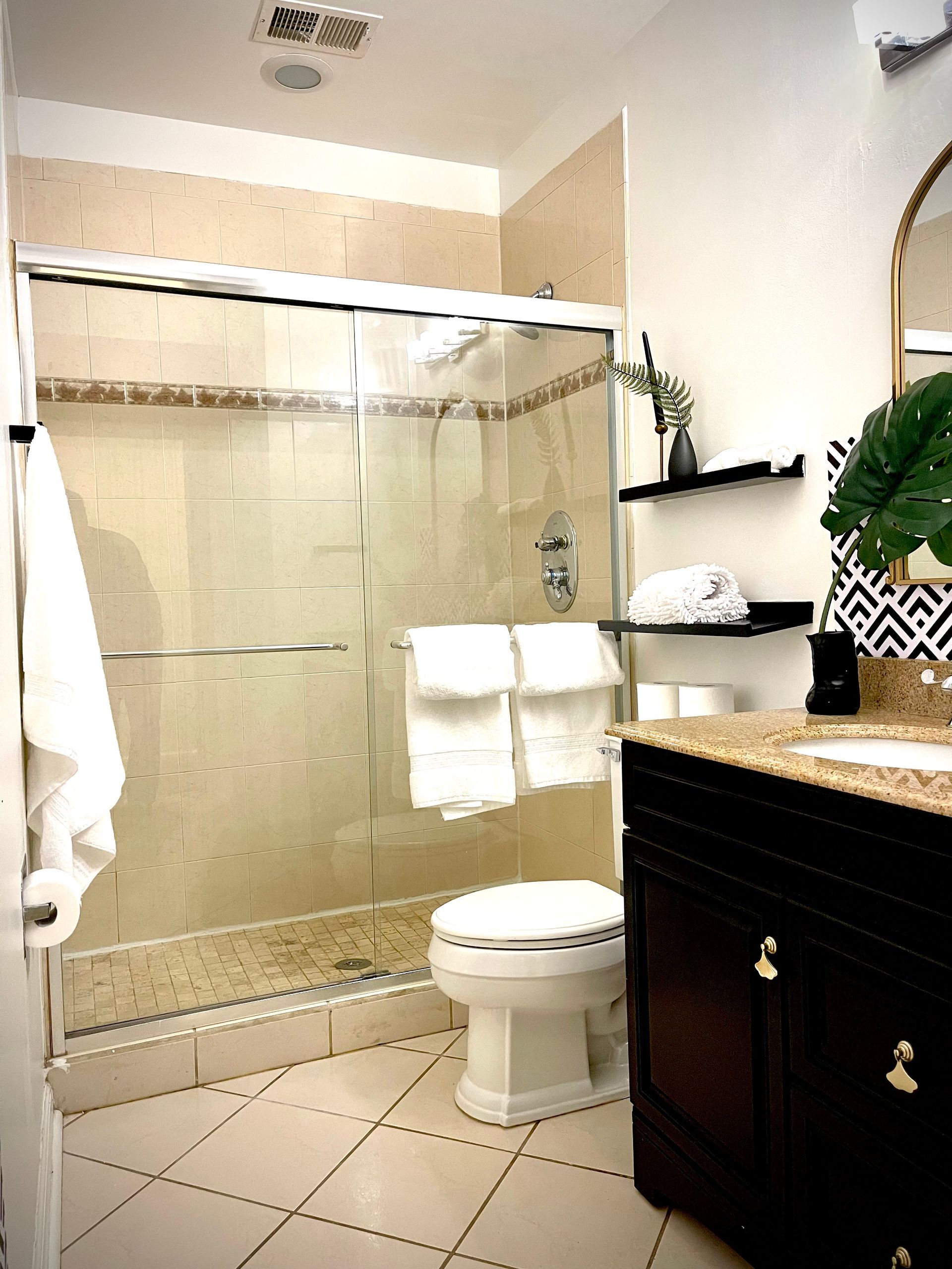 A bathroom with a toilet a sink and a shower