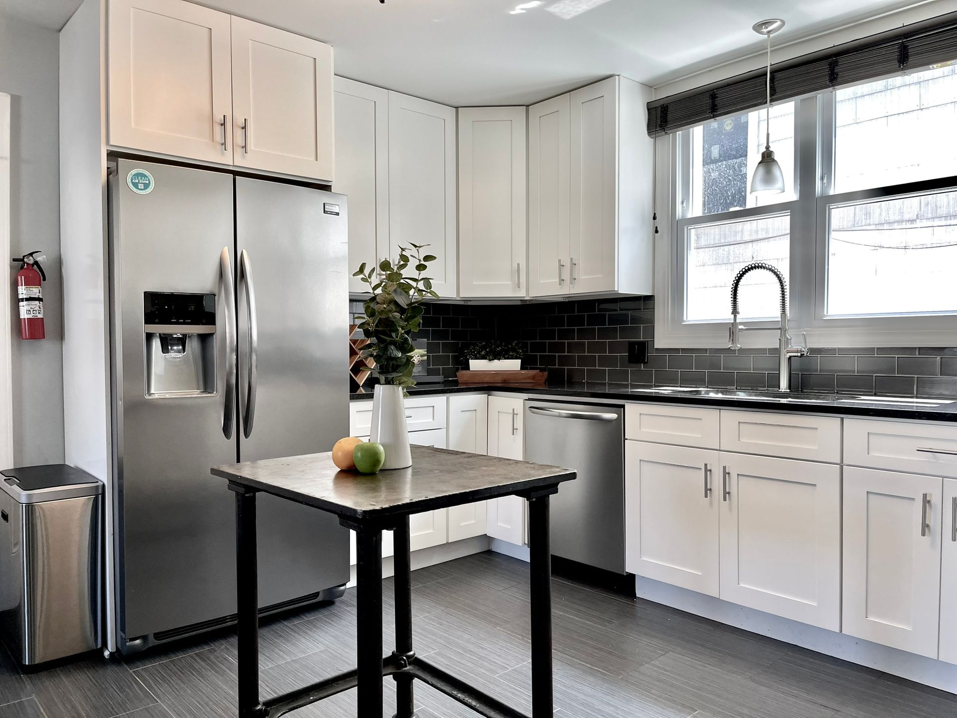 A kitchen with stainless steel appliances and white cabinets