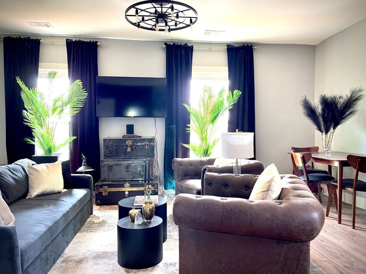 A living room with a couch , chair , table and television.