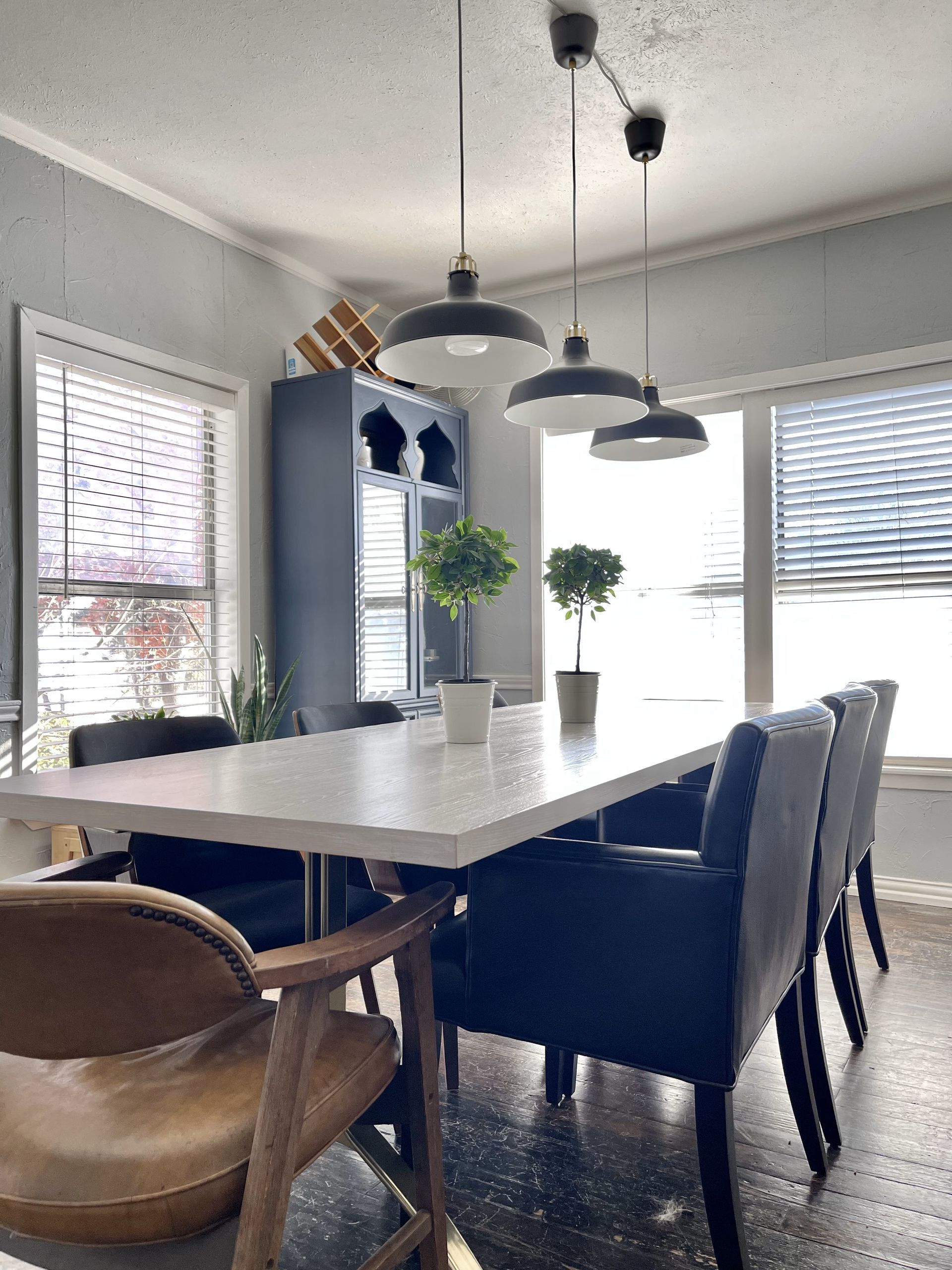 A dining room with a long table and chairs