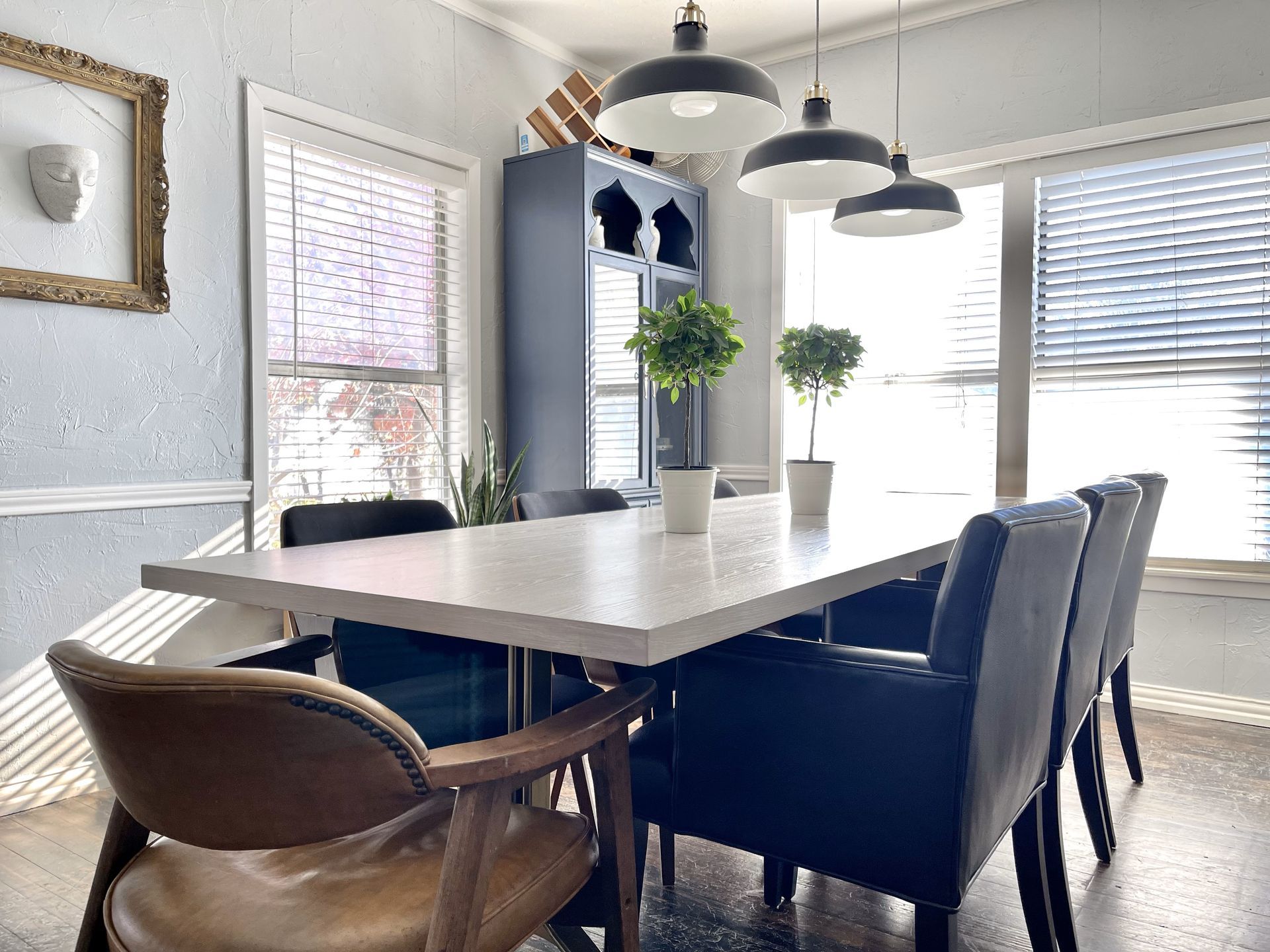 A dining room with a long table and chairs
