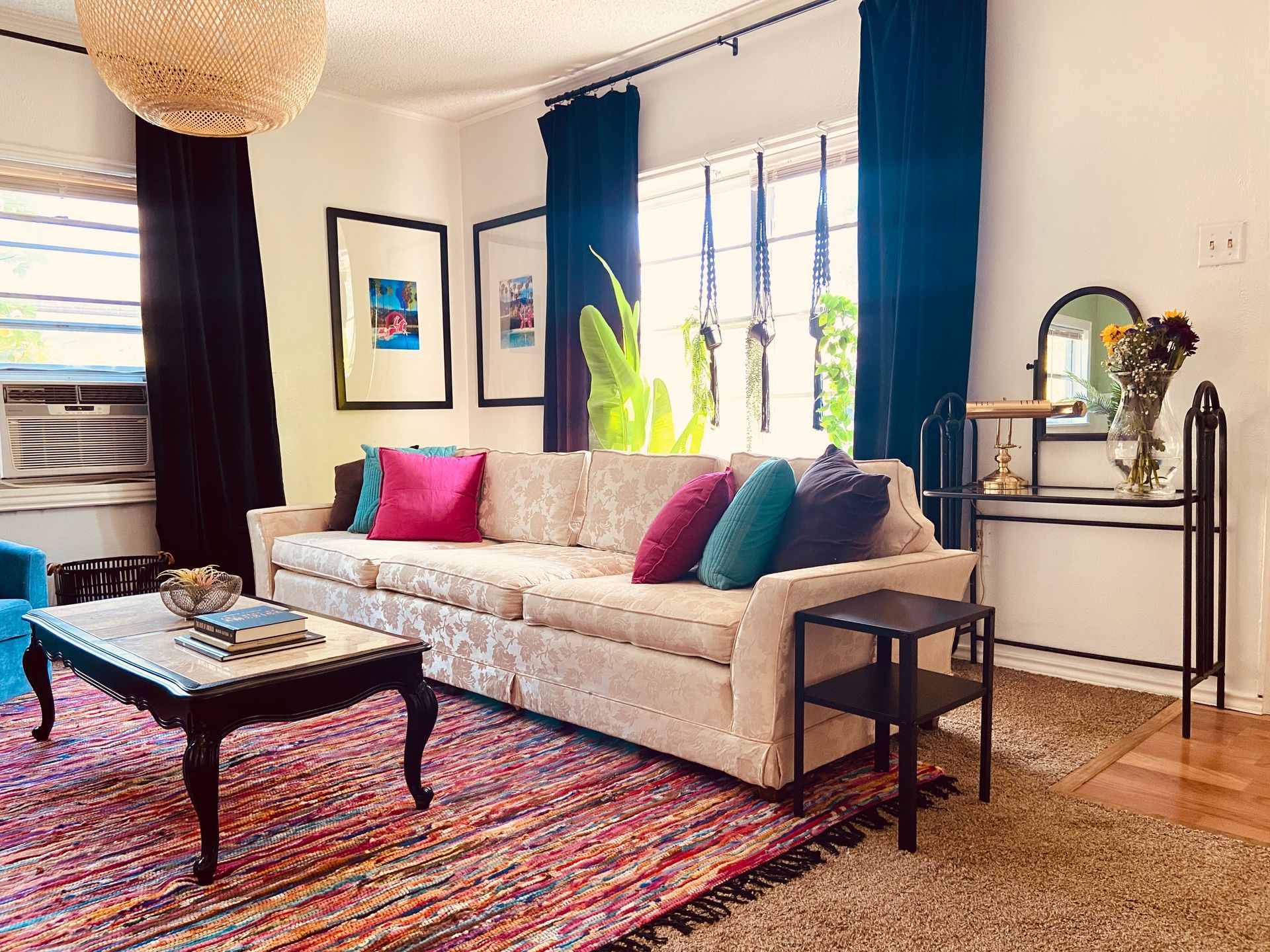 A living room with a couch , coffee table , and rug.