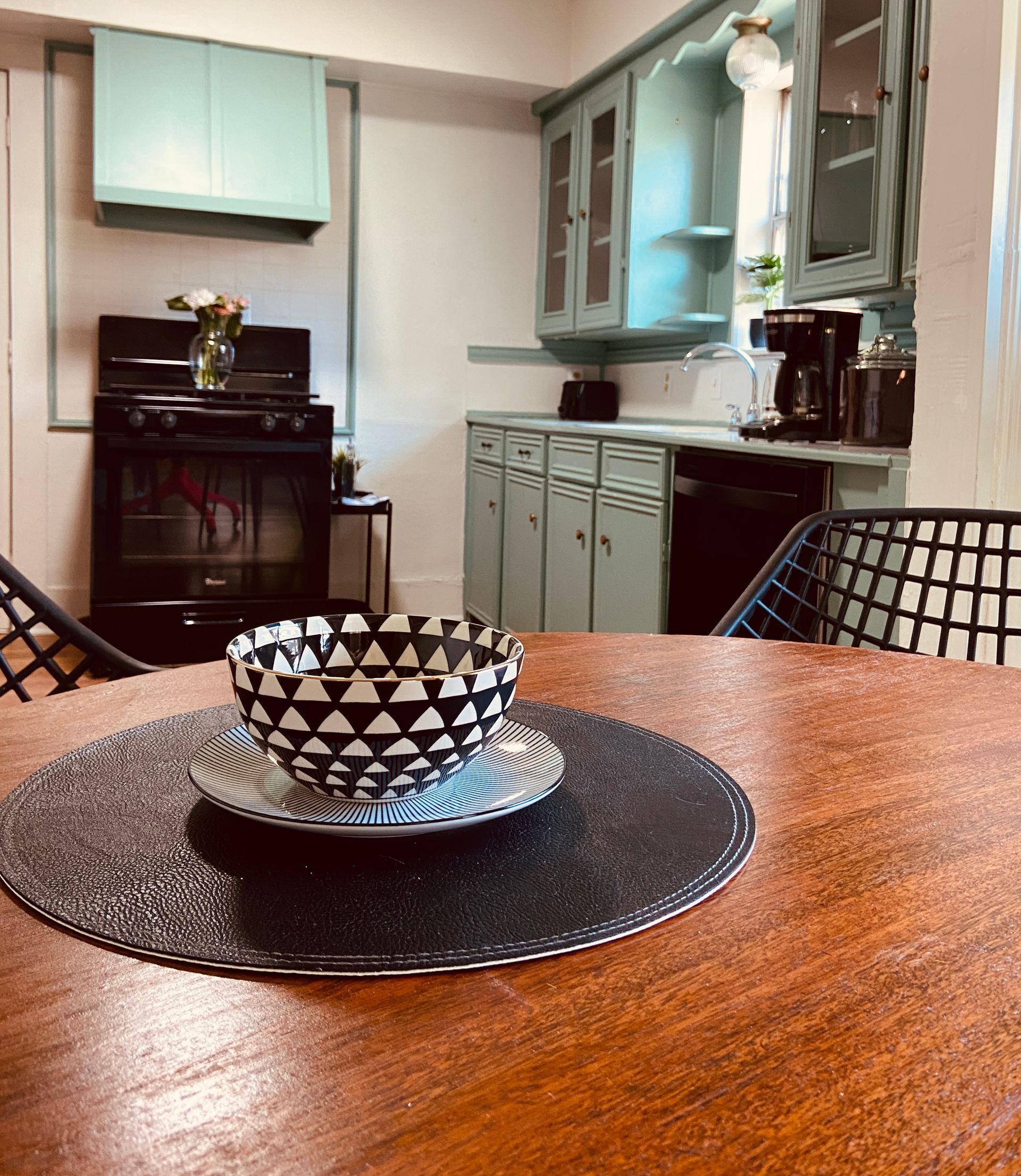 A bowl and saucer on a table in a kitchen