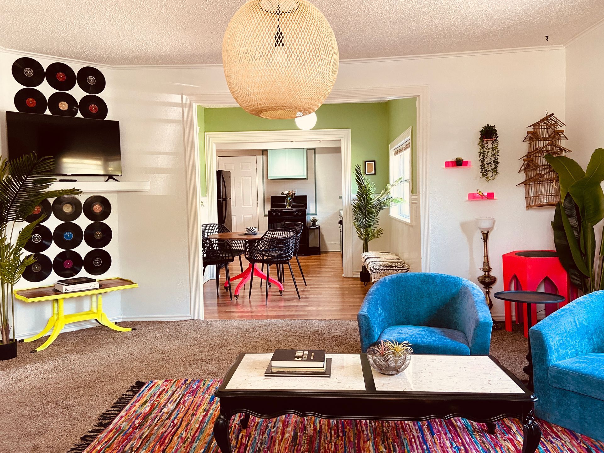 A living room with two blue chairs and a coffee table.