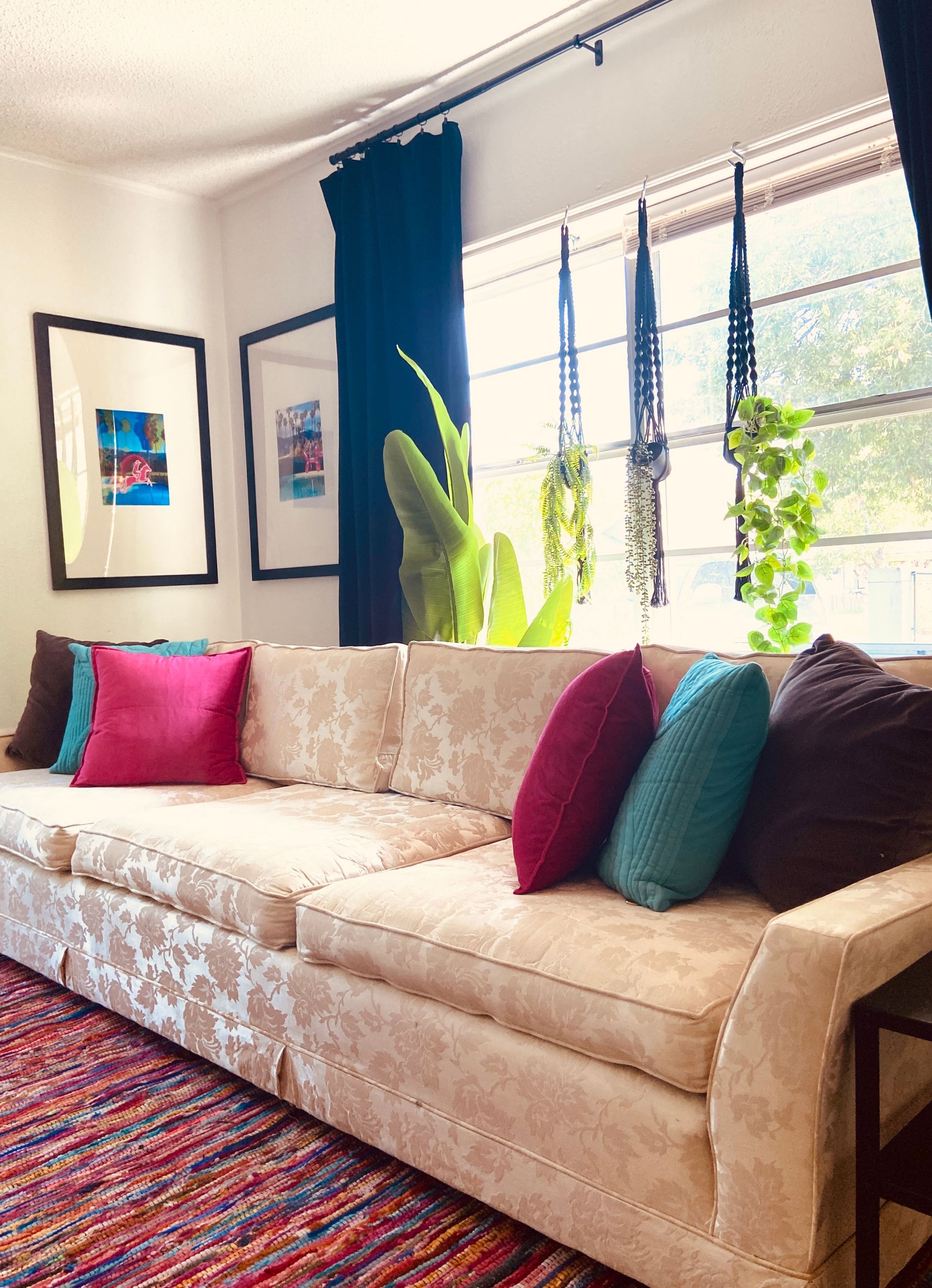 A living room with a couch and colorful pillows