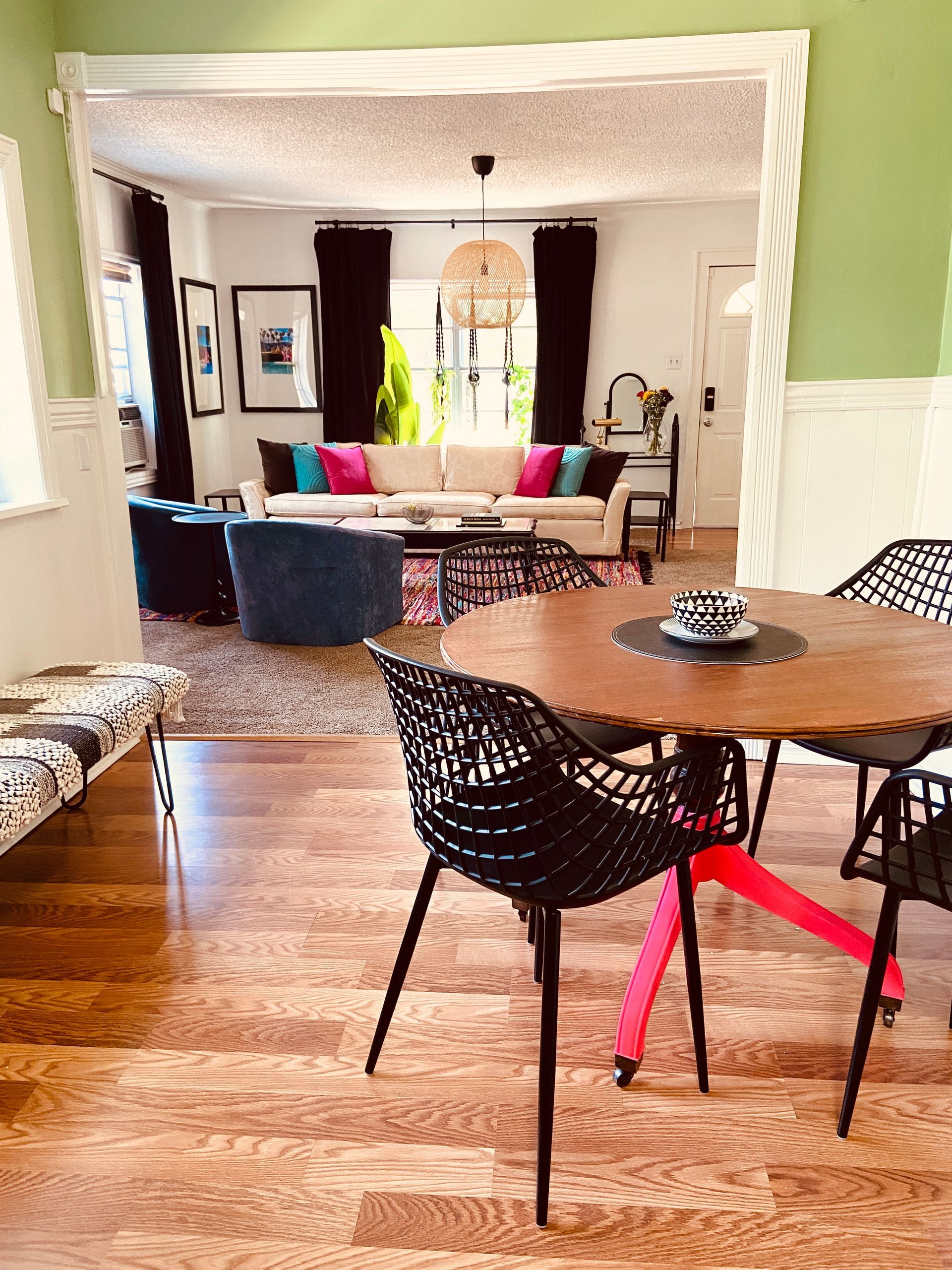 There is a table and chairs in the middle of the room.