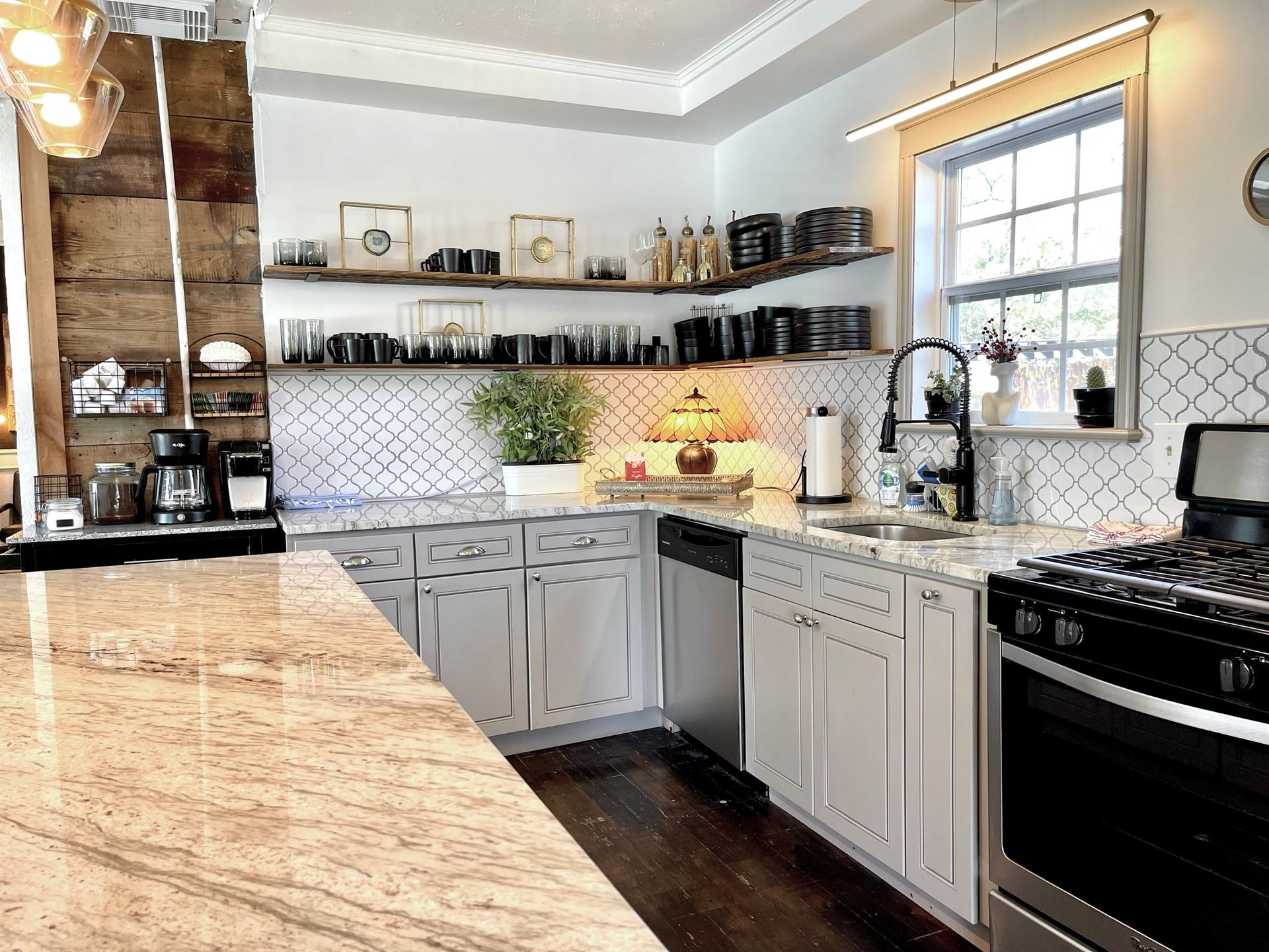 A kitchen with granite counter tops and stainless steel appliances
