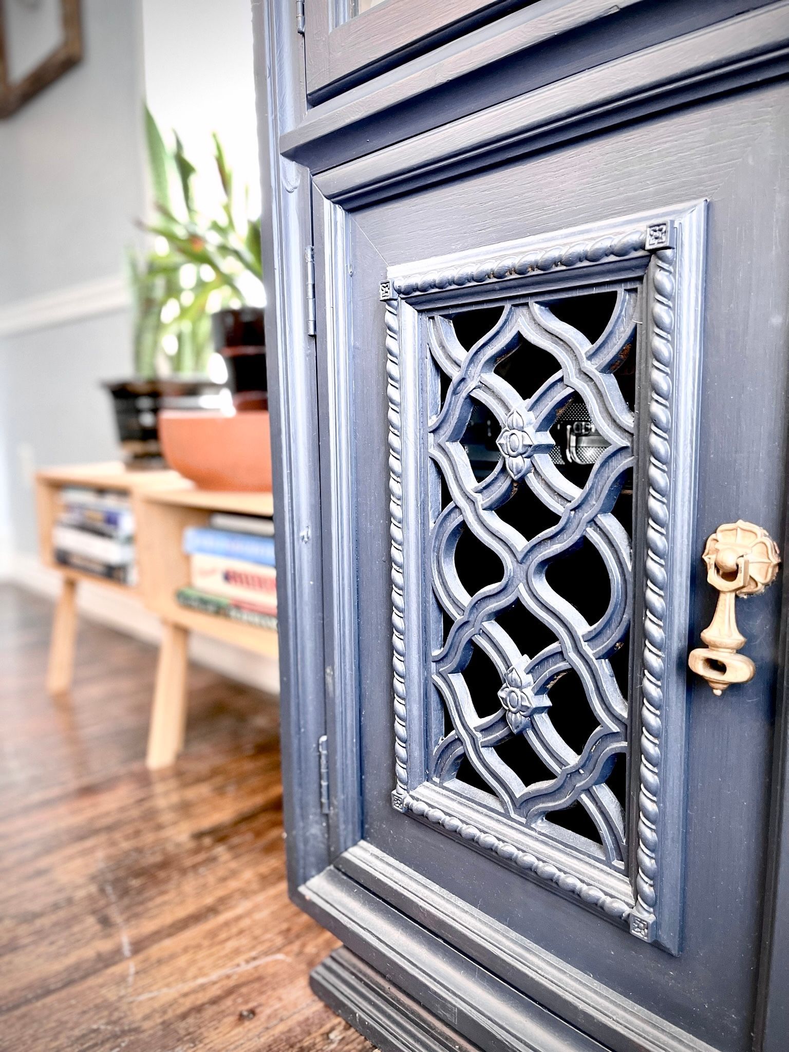 A close up of a door with a fancy design on it in a living room.