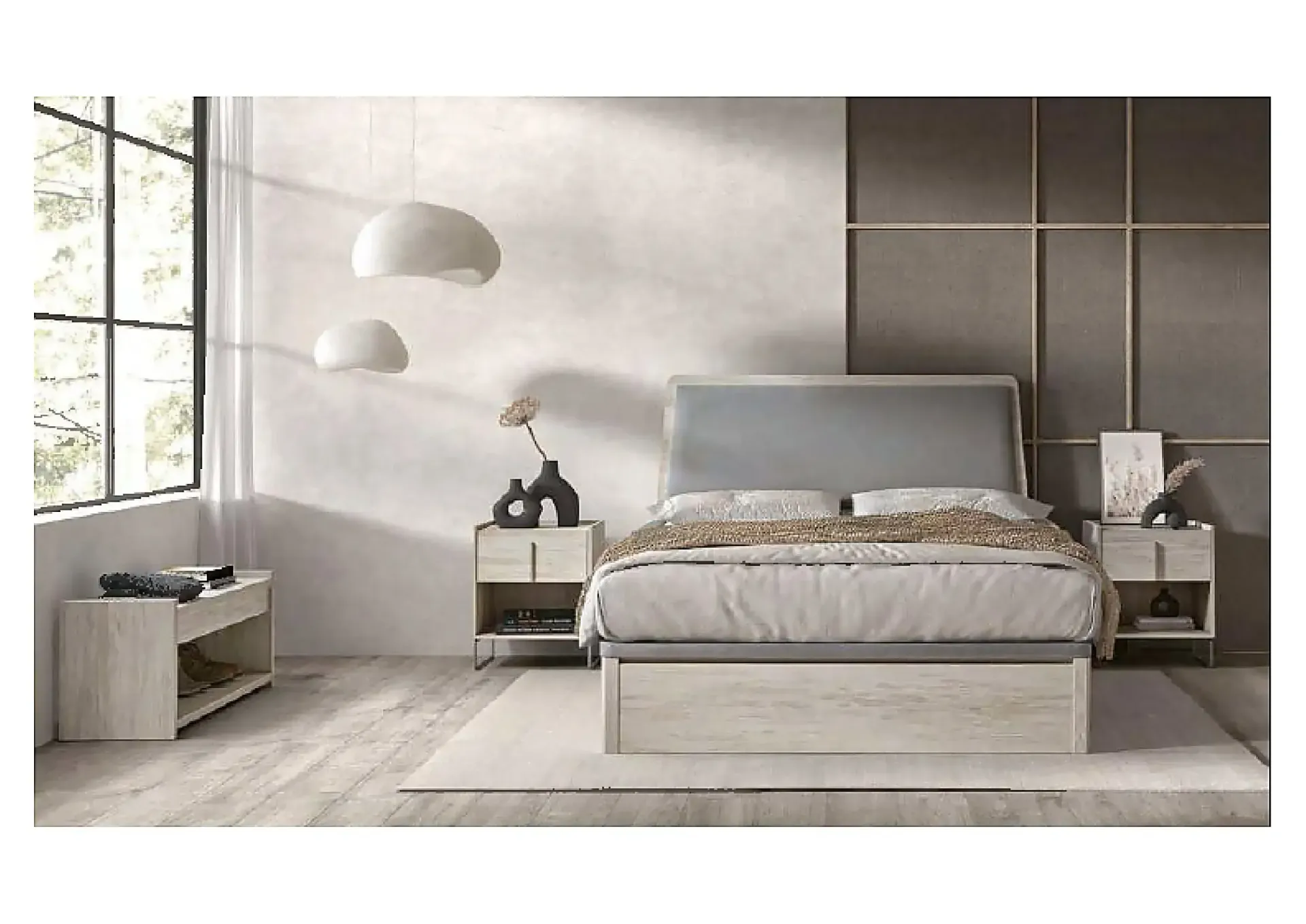 Dormitorio moderno con cama tapizada en gris, colchón blanco, almohadas negras y una manta oscura.