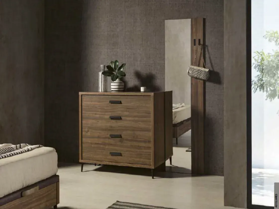 Cómoda de madera con planta en un dormitorio moderno junto a un espejo y una cama.