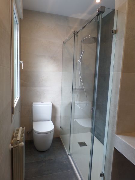 Un cuarto de baño con inodoro y ducha.