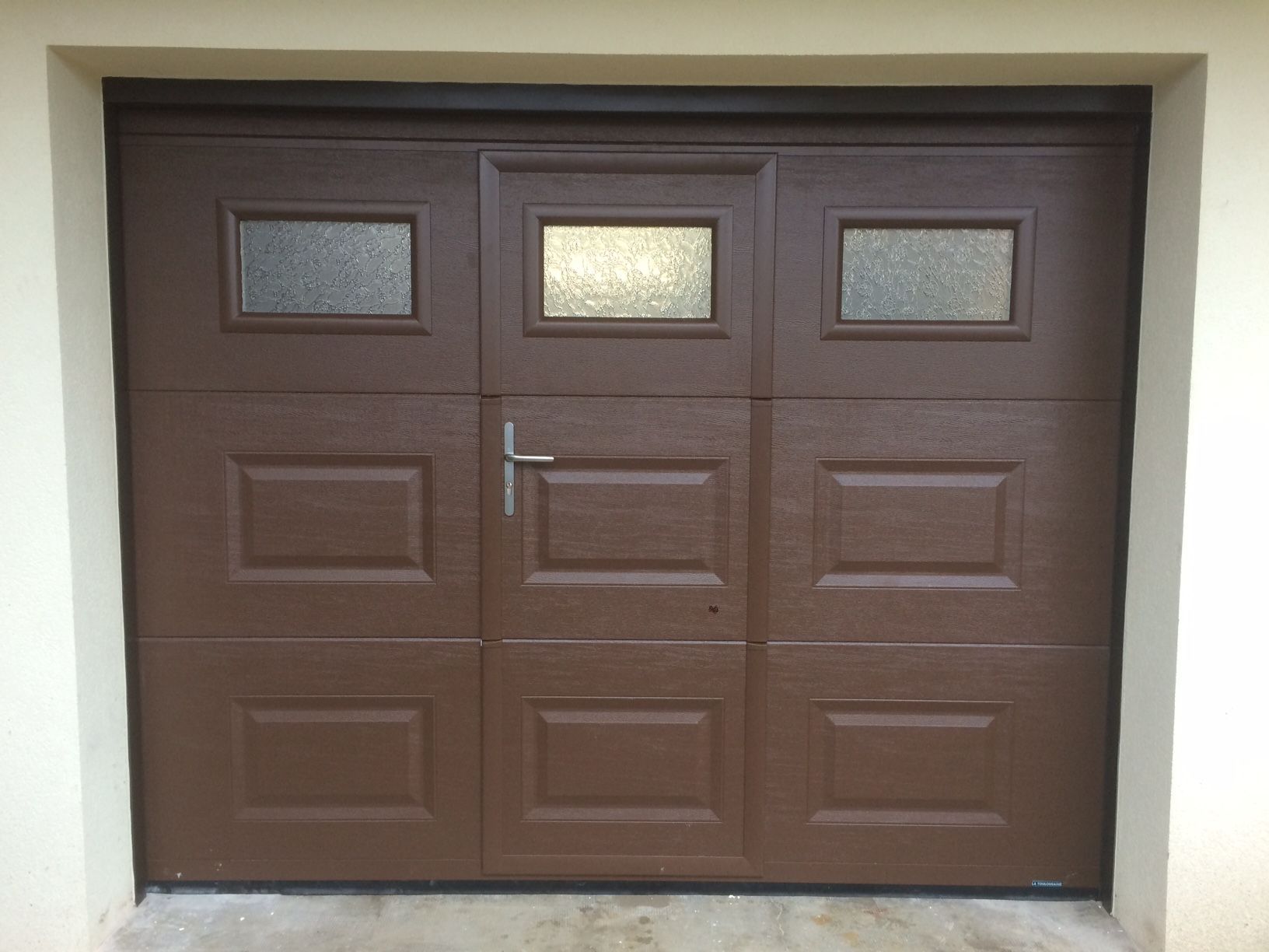 Porte de garage marron avec porte centrale