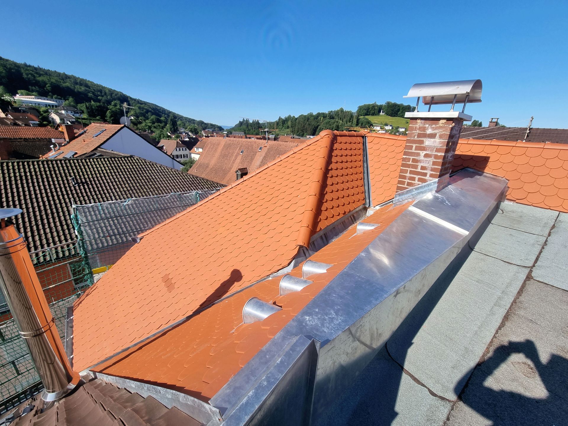 ein Dach mit roten Ziegeln und einem Schornstein darauf