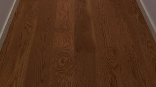 Piso de madera de color marrón oscuro con detalles en blanco.