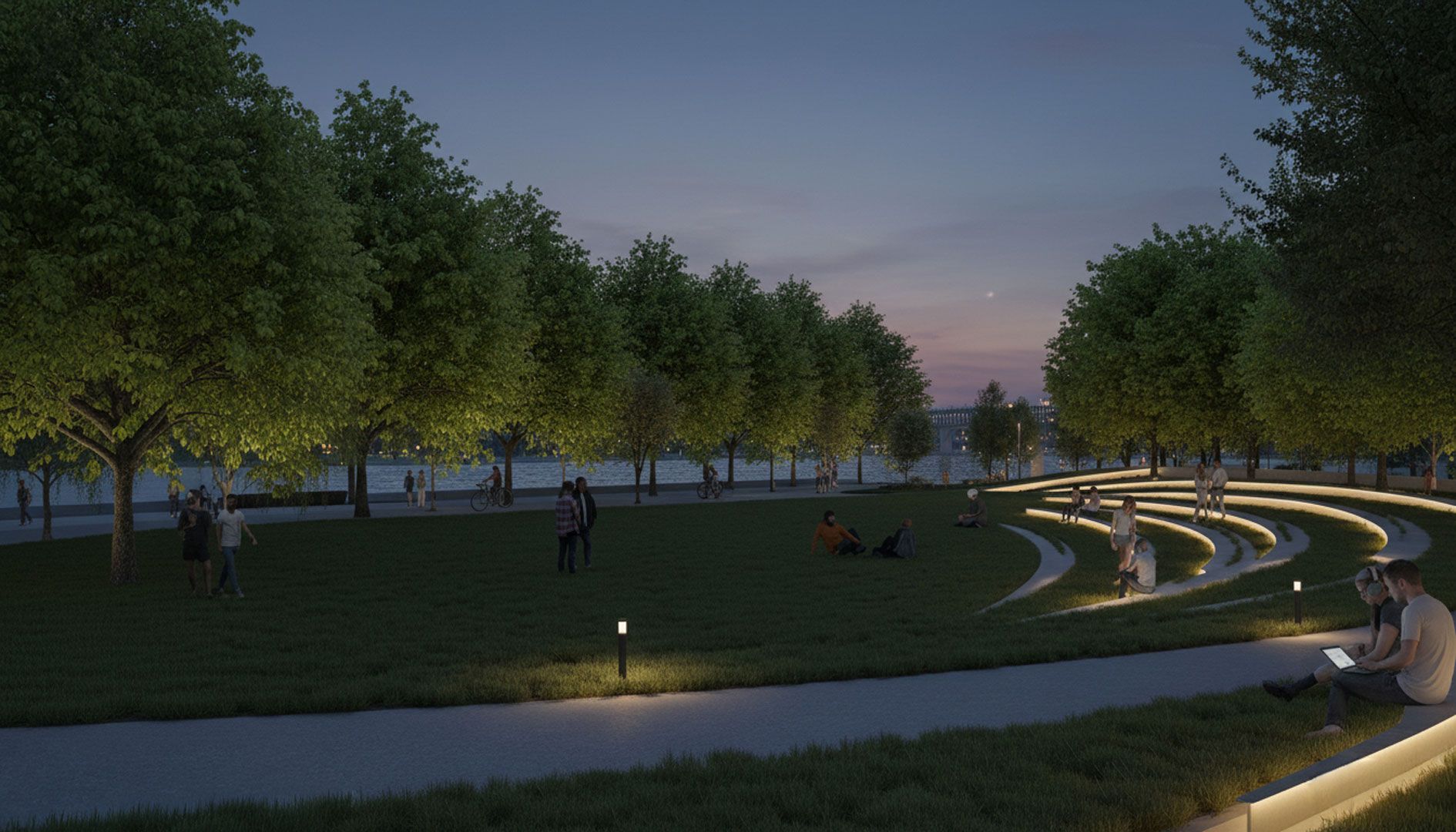 Vue nocturne d'un parc avec des arbres illuminés, des gradins et des personnes se détendant sur l'herbe.